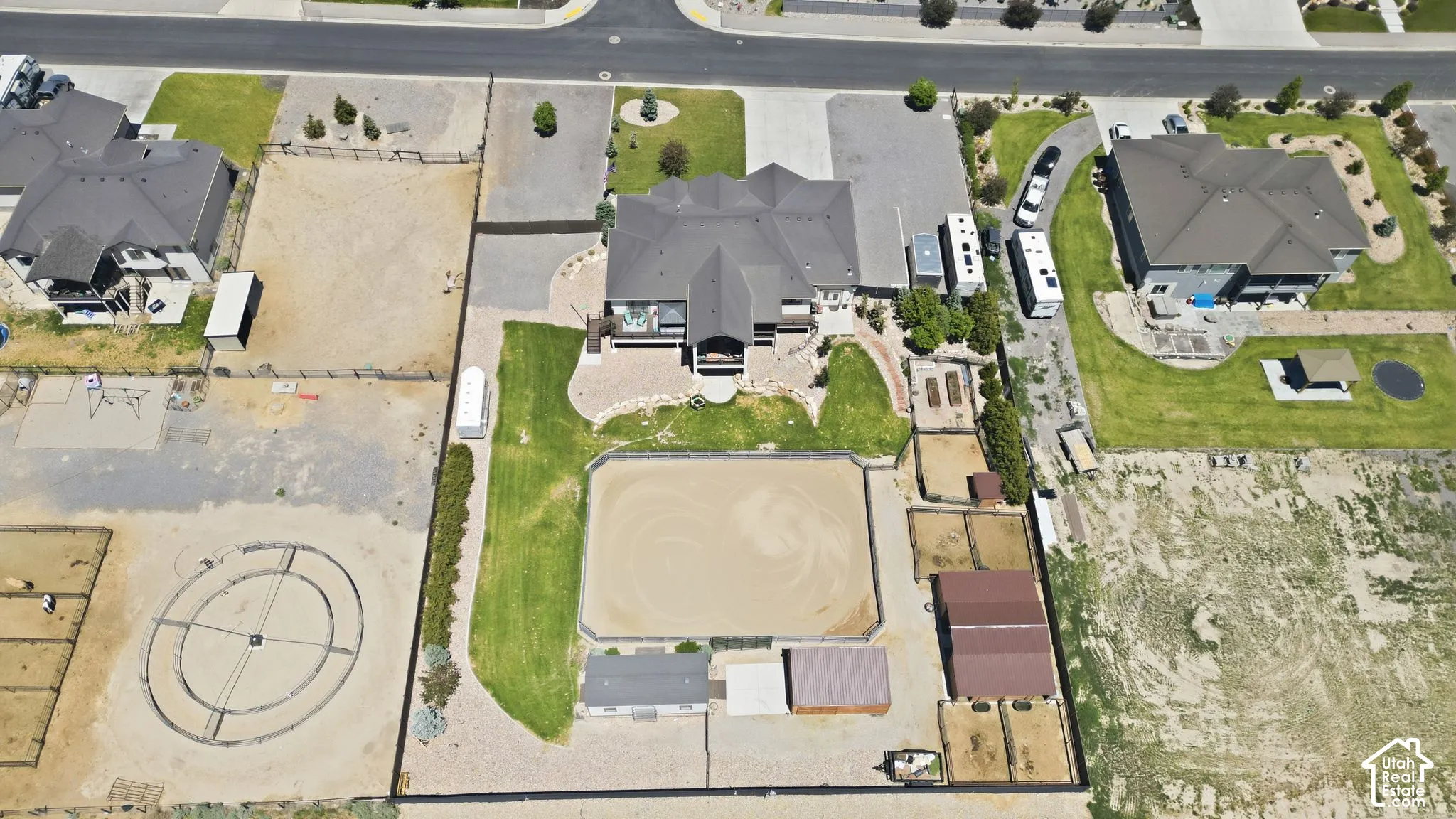 Expansive property featuring a central residence, a sizable riding arena, multiple outbuildings, and a circular training pen