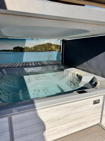 Integrated spa tub with a multi-jet design, interior lighting, and a wood-finish surround