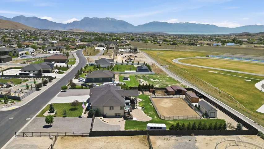 Expansive property featuring a private equestrian arena, multiple outbuildings, and mature privacy landscaping