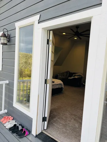 Exterior siding in a dark gray finish with white trim