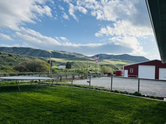 Expansive green lawn with mountain backdrop