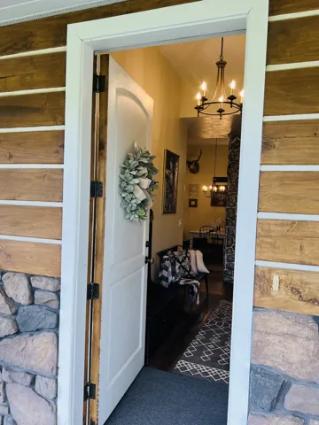 Rustic exterior featuring stacked stone and natural wood siding
