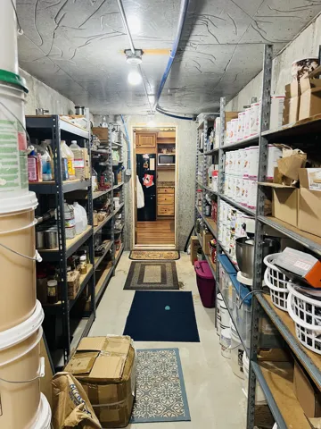 Utility room featuring concrete flooring and exposed ceiling with conduit