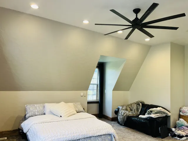High ceilings with recessed lighting and a large ceiling fan
