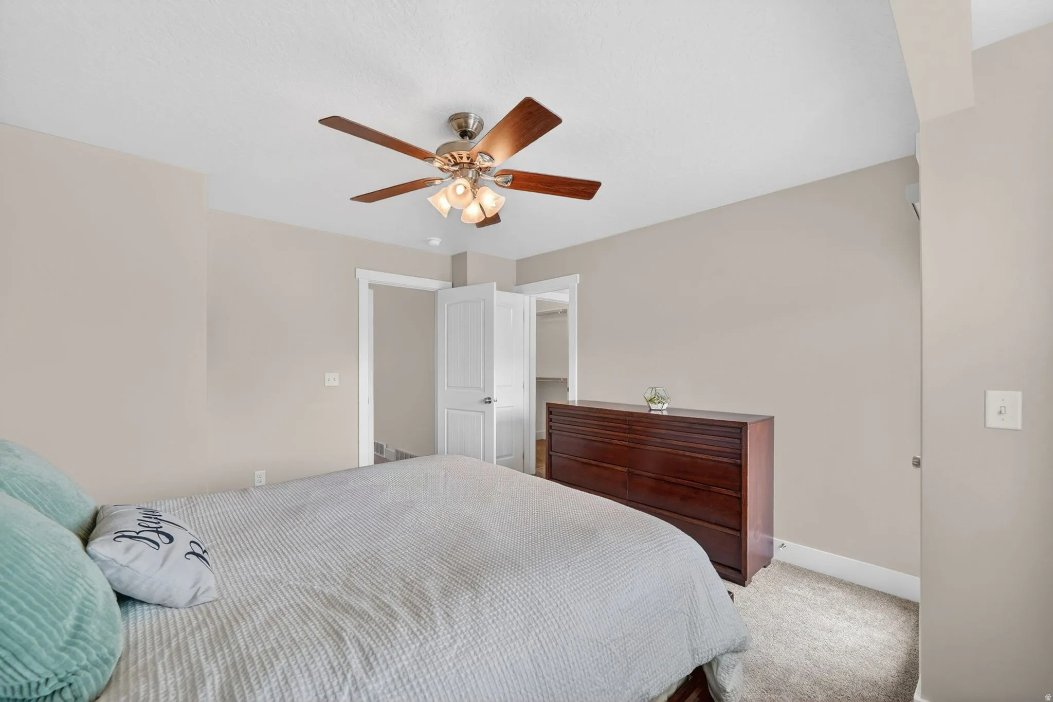 Neutral-toned walls complement plush carpeting