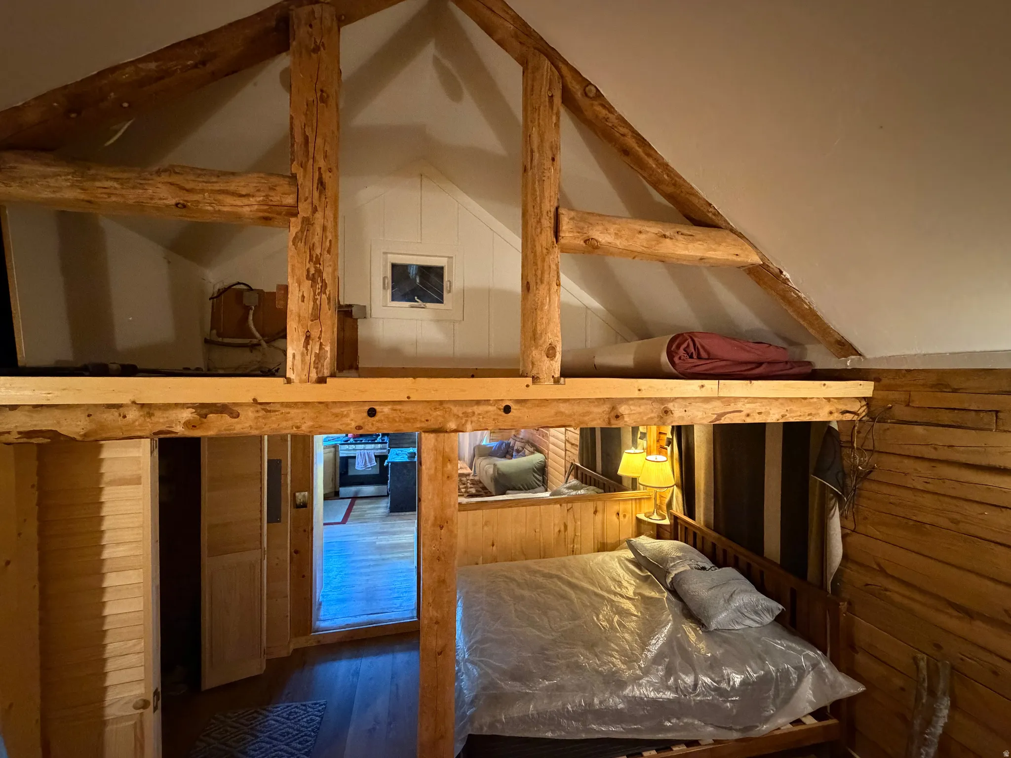 Rustic interior featuring natural wood paneling and exposed log beams