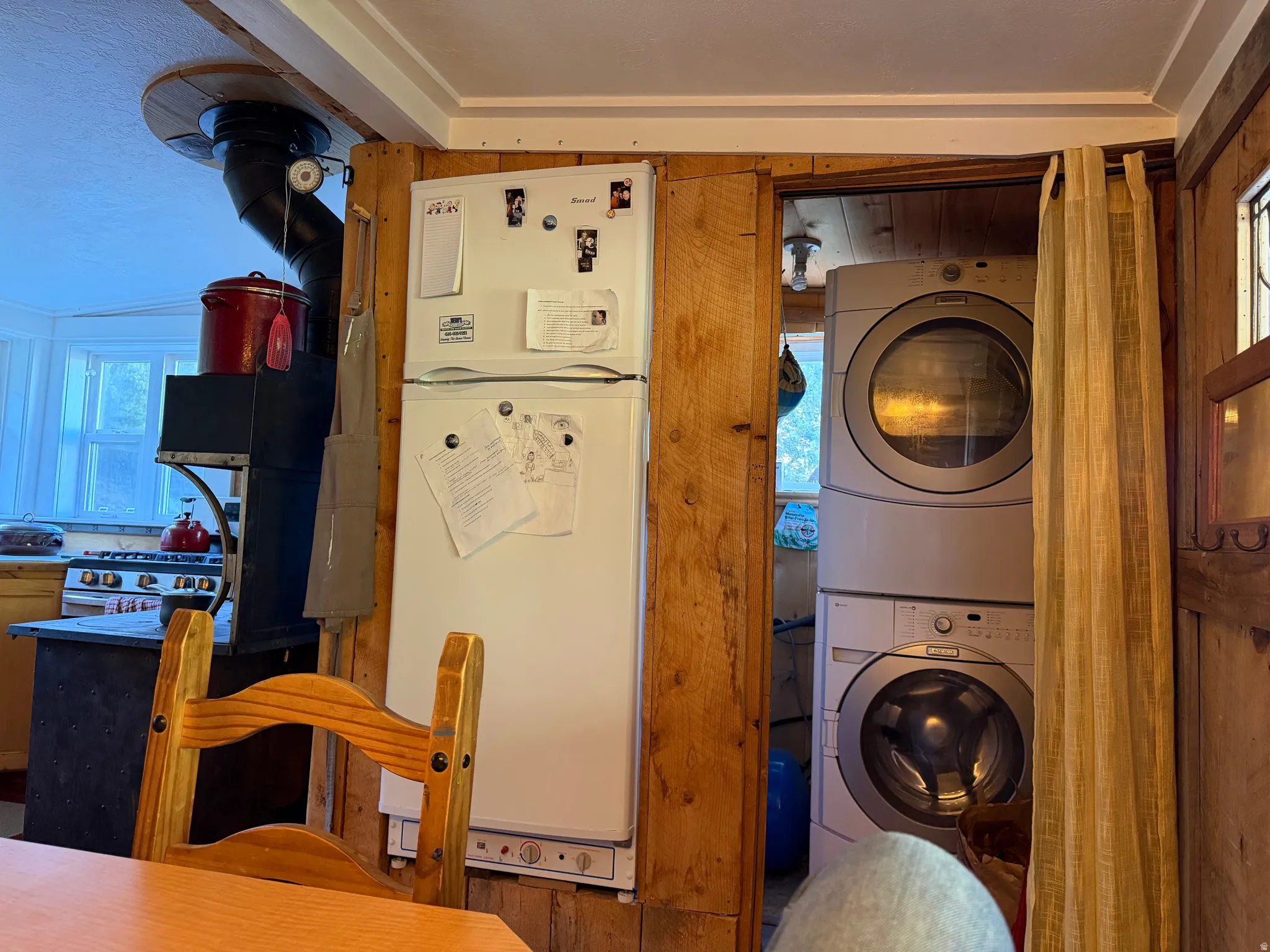 Freestanding refrigerator with adjacent stackable washer and dryer