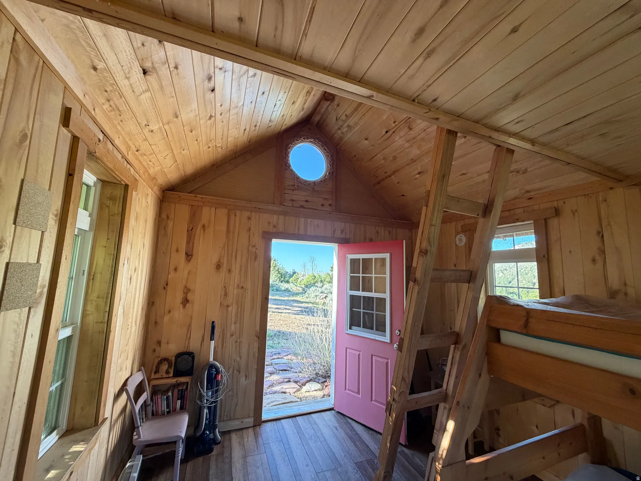 Interior space featuring wood-finish walls and vaulted wood-finish ceiling