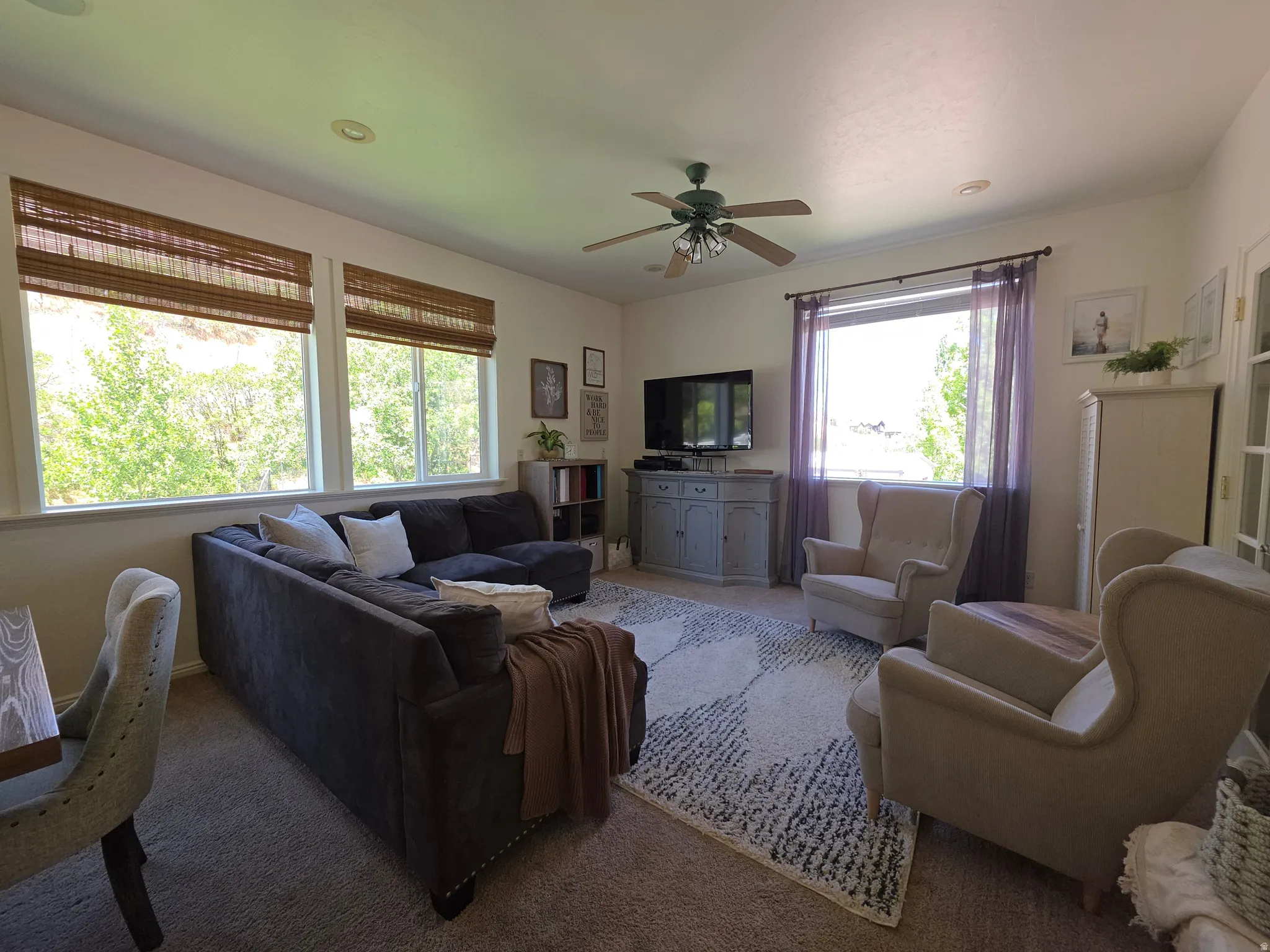 Living area featuring recessed lighting, a ceiling fan, and carpeted flooring