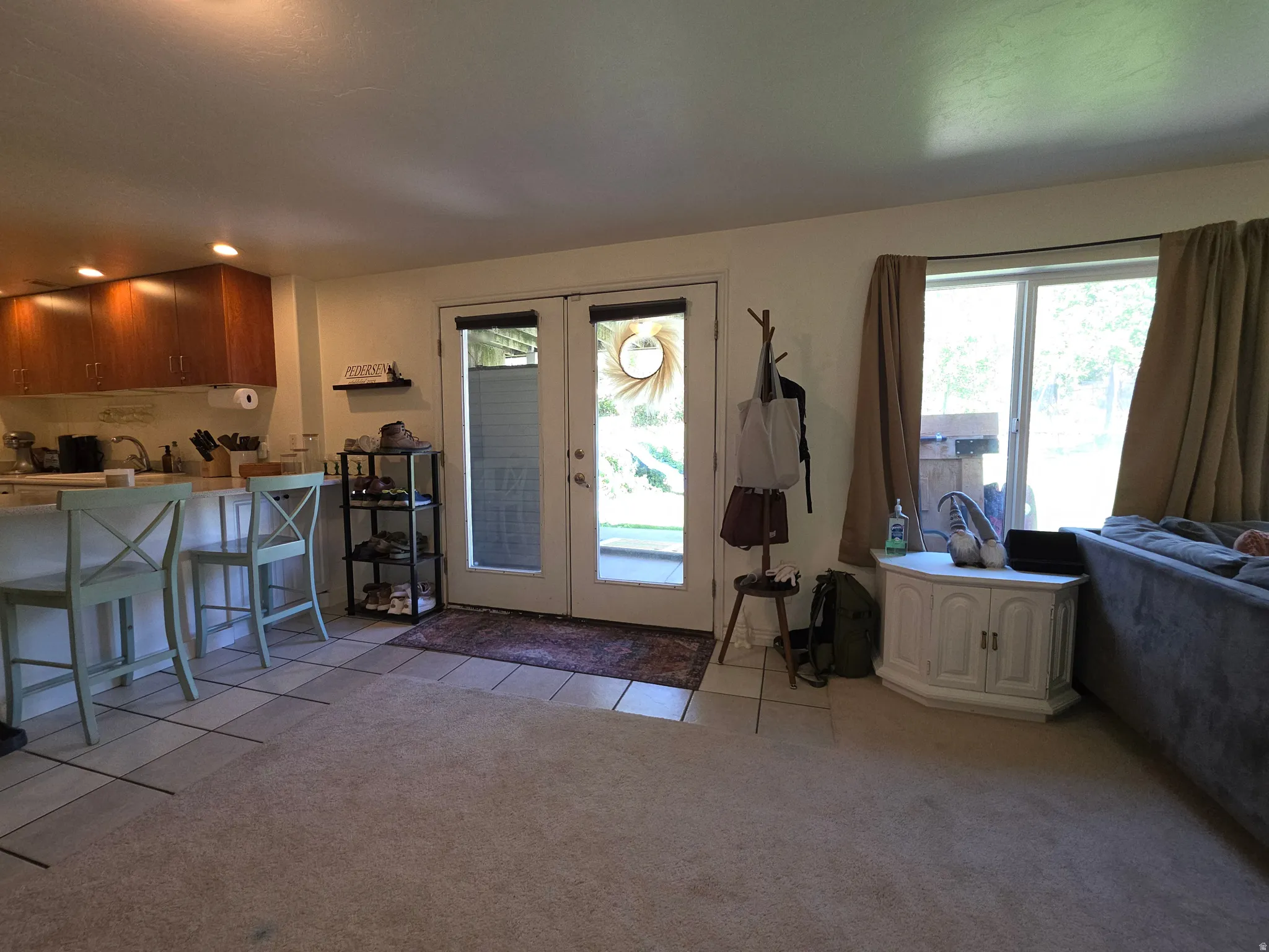 Outside ground level walk -in basement with Kitchenand great room bar seating with light countertops and wood cabinetry