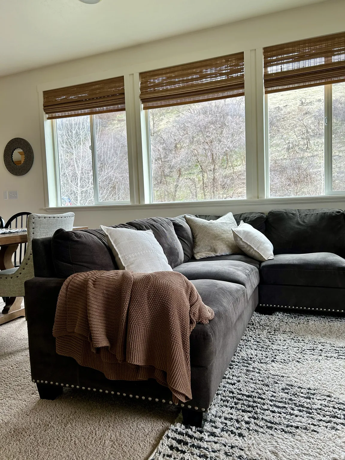 Triple window array featuring woven wood blinds and a recessed ceiling light