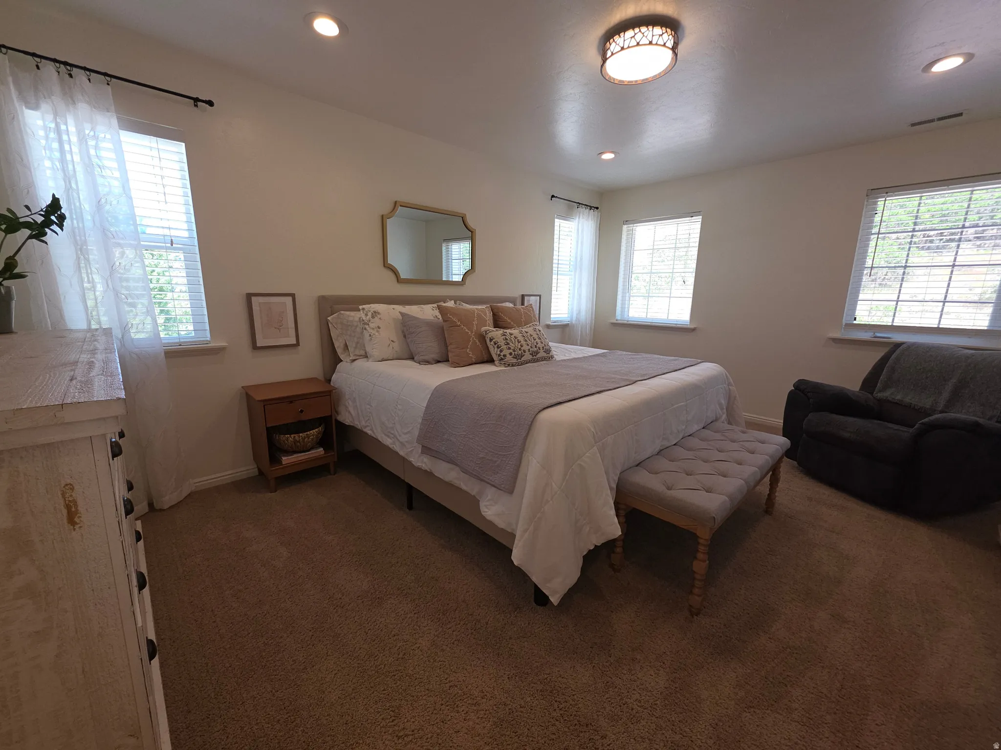 Carpeted bedroom featuring recessed lighting and a central flush-mount light fixture