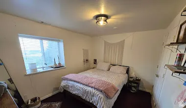 Daylight bedroom #6   Can be an ADU. Bright interior featuring wood-finish flooring and a flush-mount ceiling light fixture