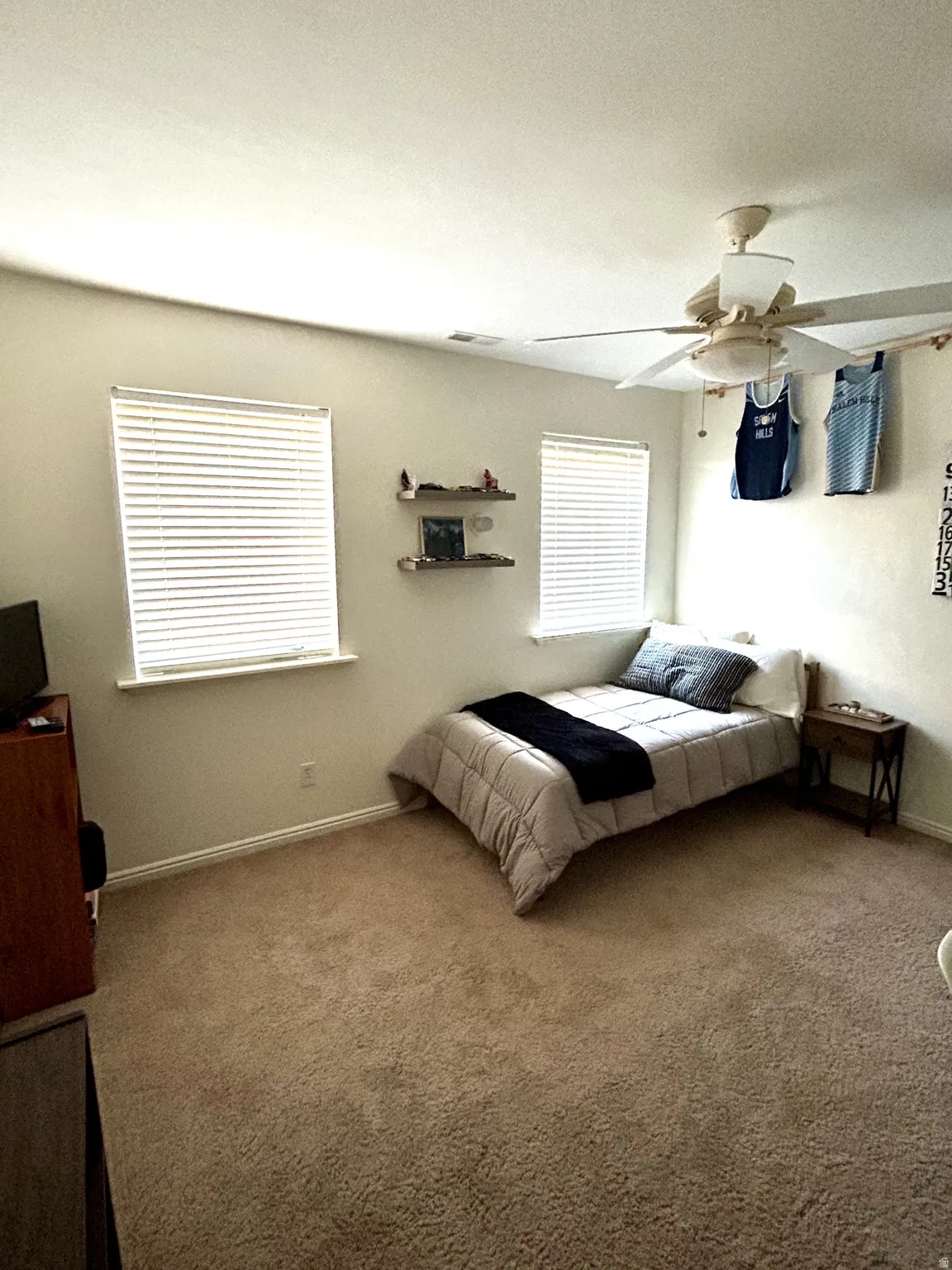 Bedroom #3 Carpeted room with two windows, a ceiling fan with integrated lighting, and neutral wall tones