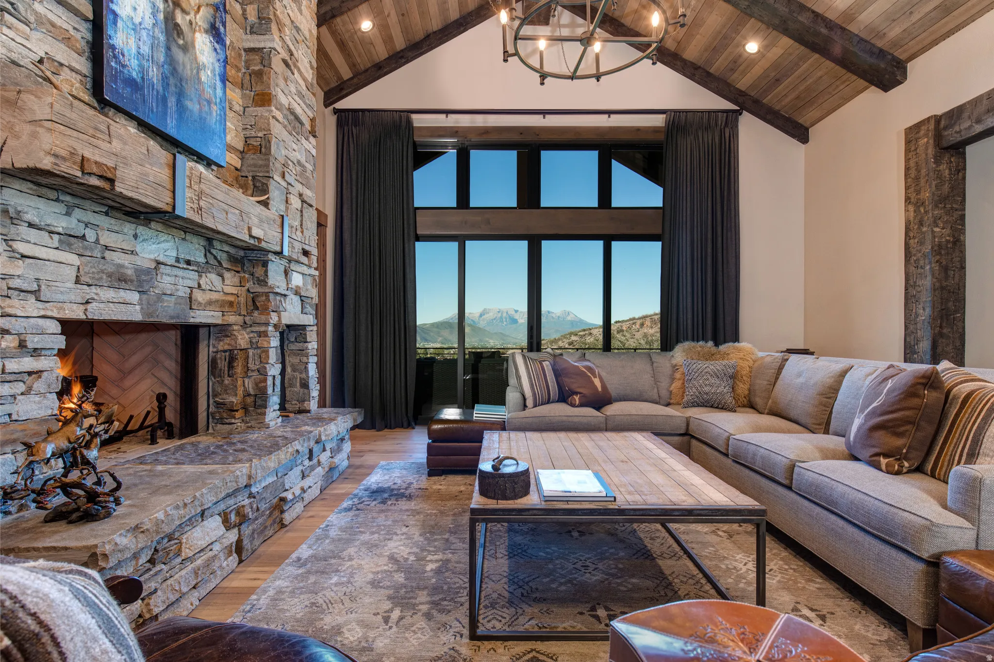 Vaulted wood-paneled ceilings with exposed beams and a chandelier
