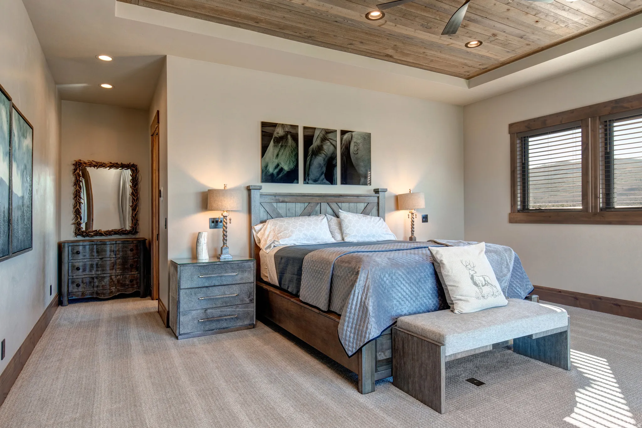 Bedroom featuring a tray ceiling with wood-finish paneling, recessed lighting, and a ceiling fan