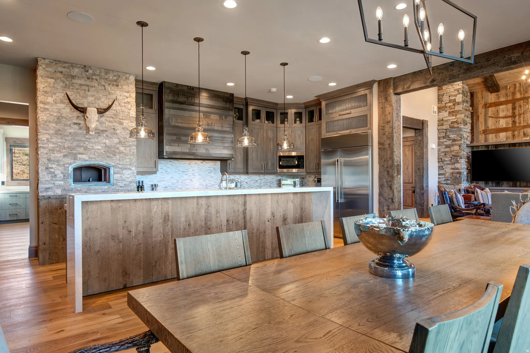 Open-concept kitchen and dining area featuring wide plank wood flooring
