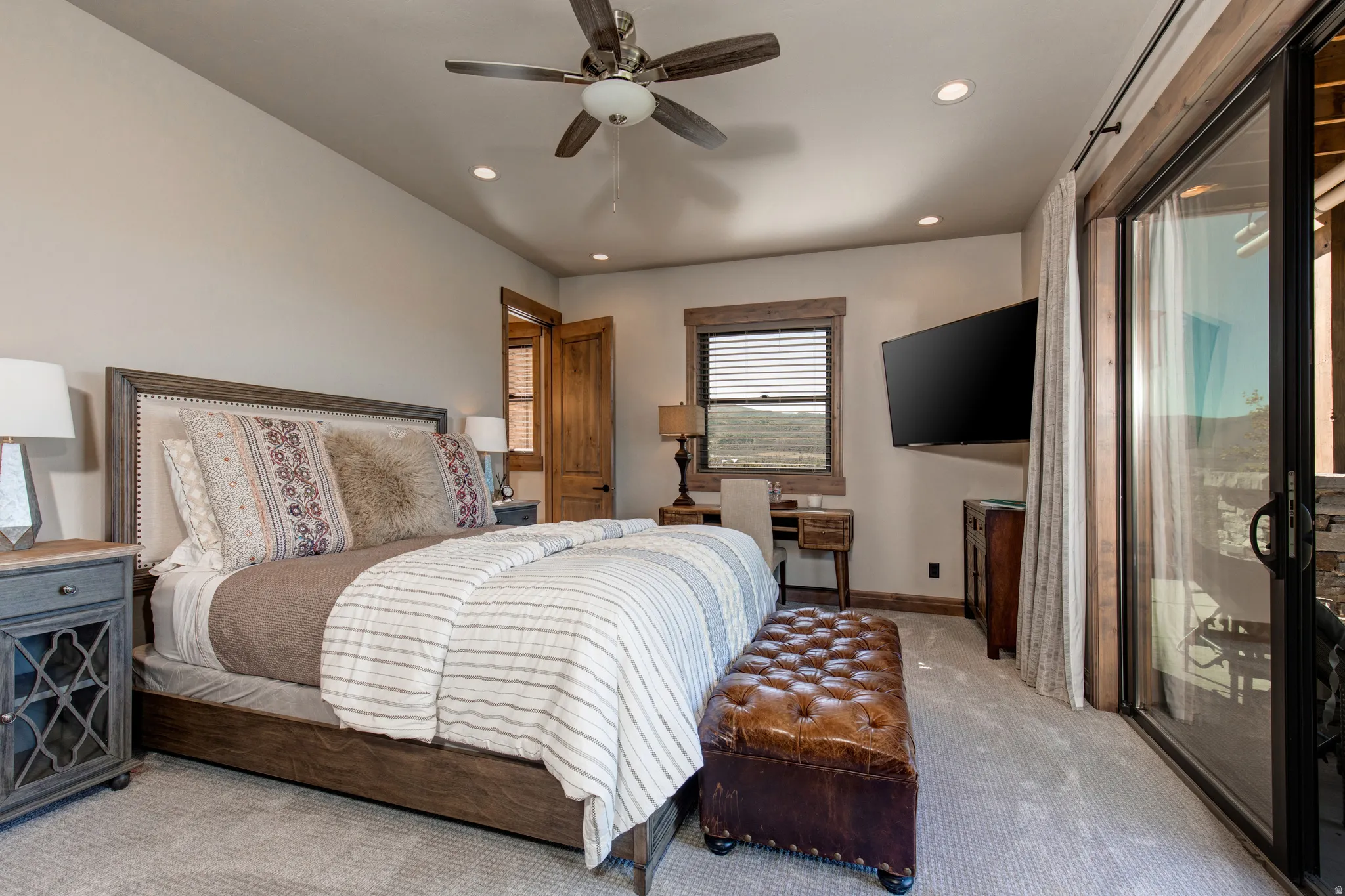 Carpeted bedroom featuring a ceiling fan, recessed lighting, and a window with blinds