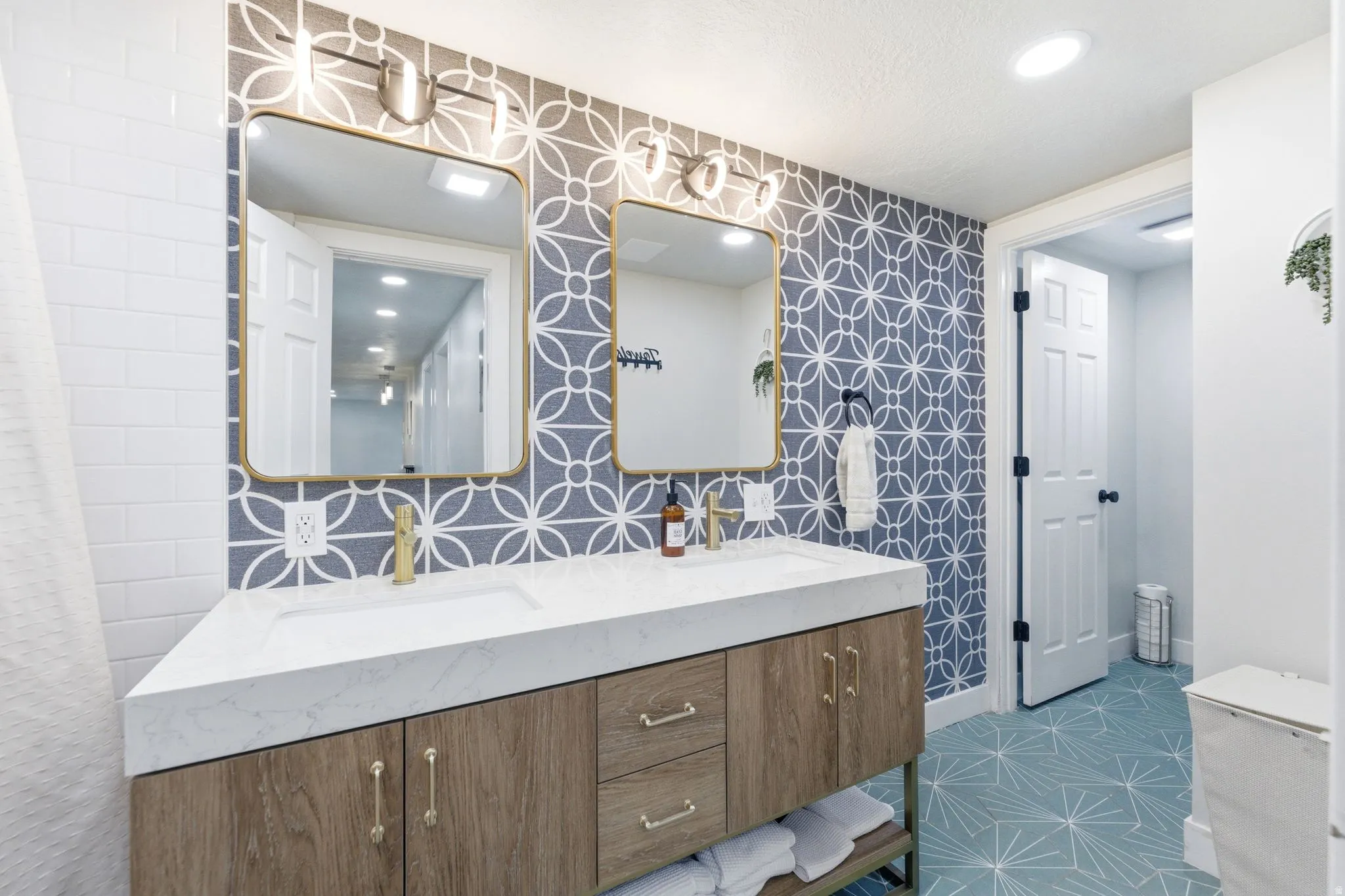 Double vanity with a white countertop featuring integrated sinks