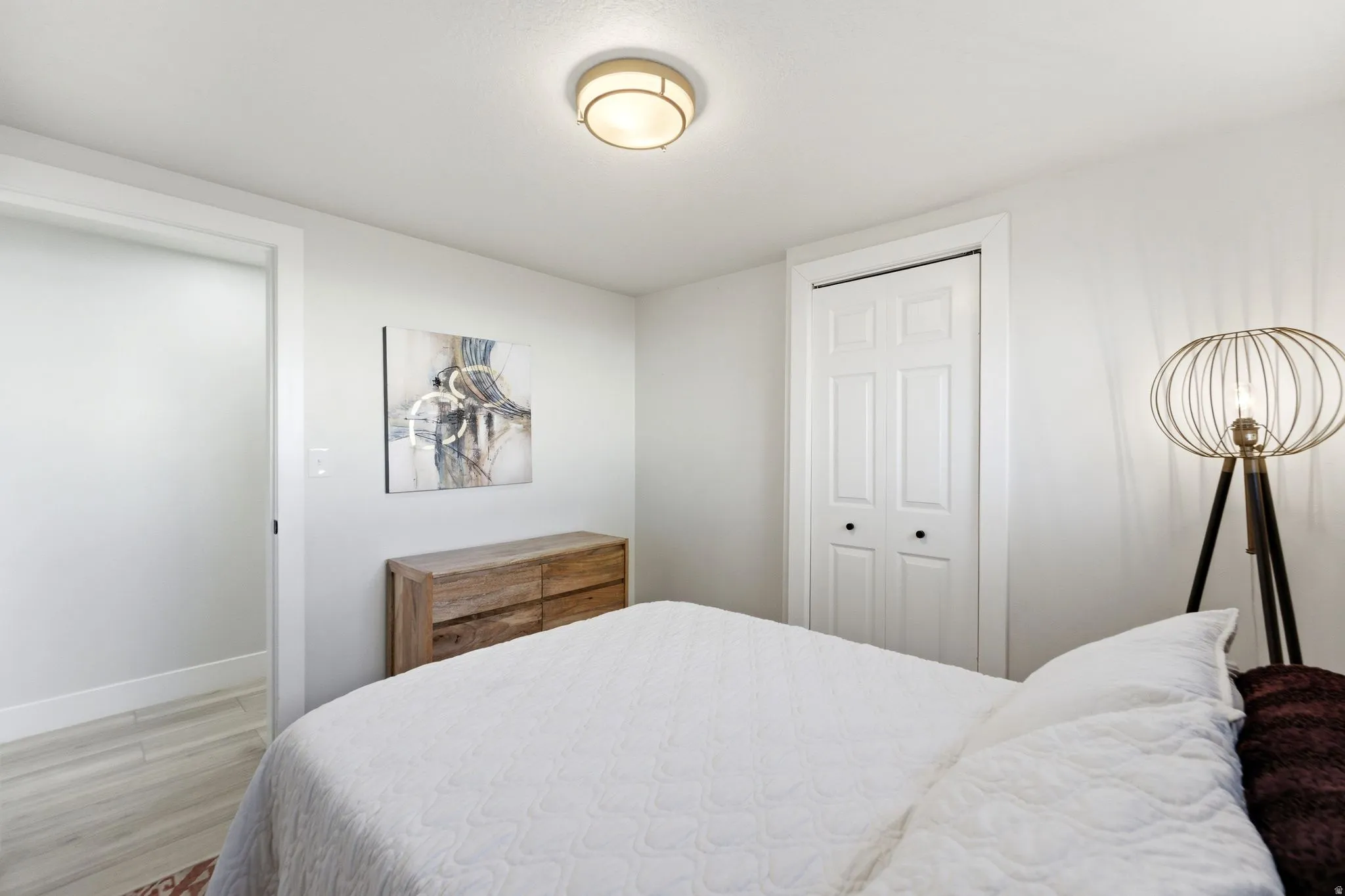 Bedroom featuring light gray walls and white trim
