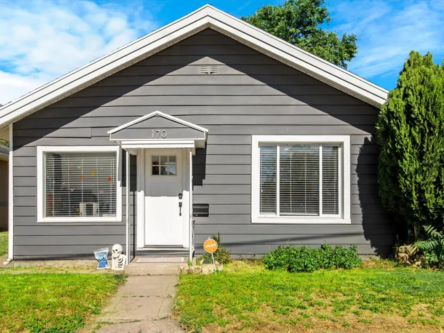 Single-story residence featuring dark gray horizontal siding and contrasting white trim