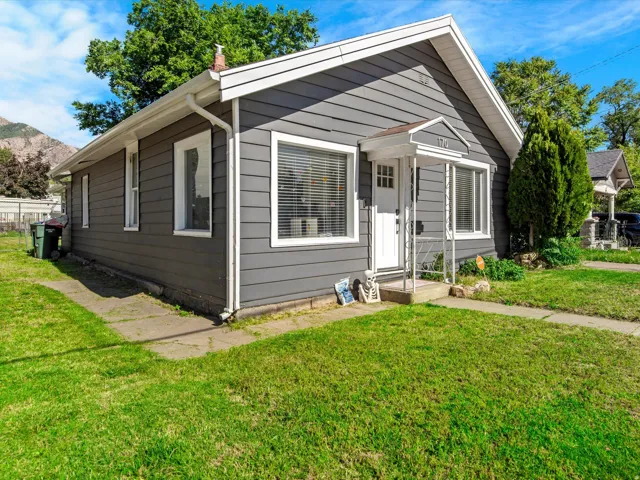 Residential property with dark gray horizontal siding and white trim