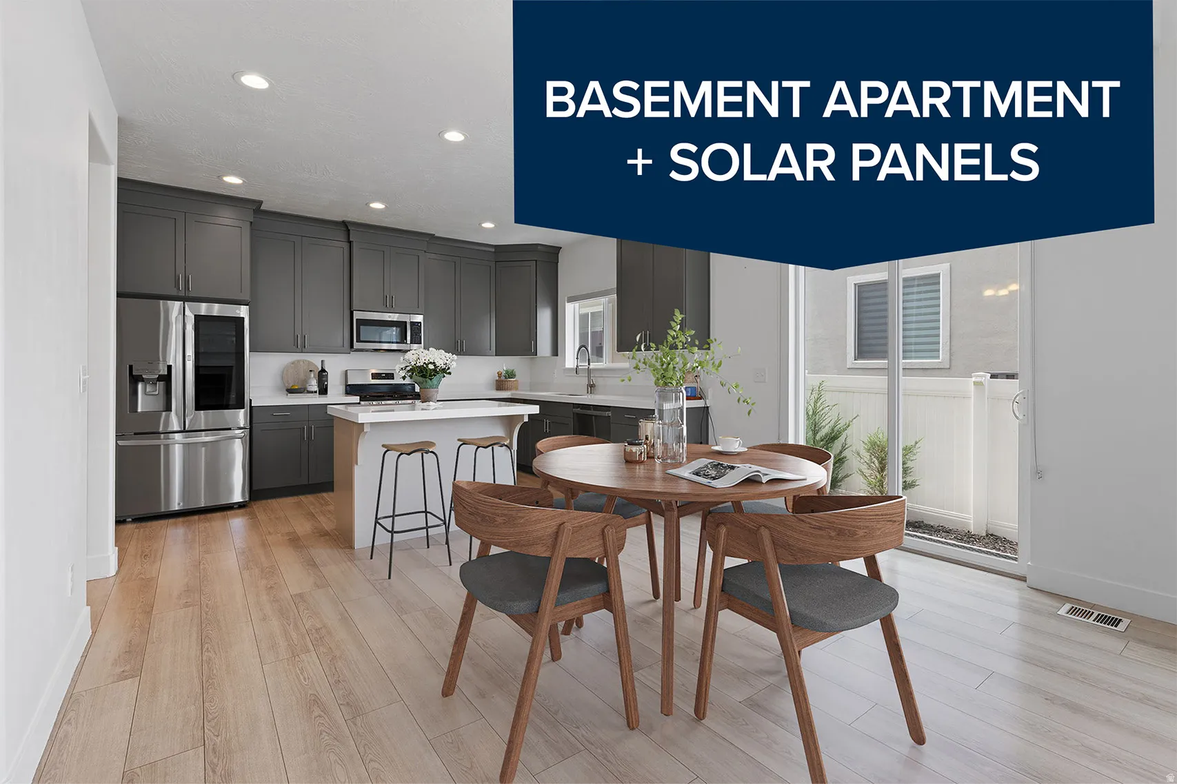 Open-concept kitchen and dining area featuring light wood-finish flooring, recessed lighting, and a kitchen island with seating