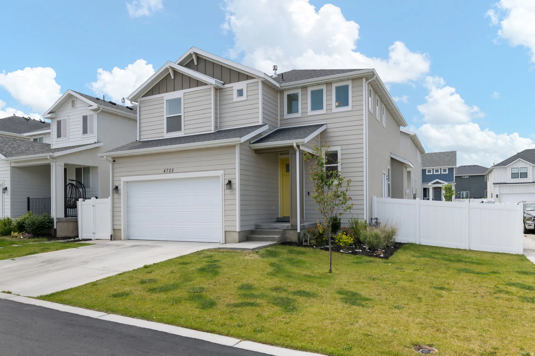 Contemporary two-story residence with light-colored siding and dark trim accents