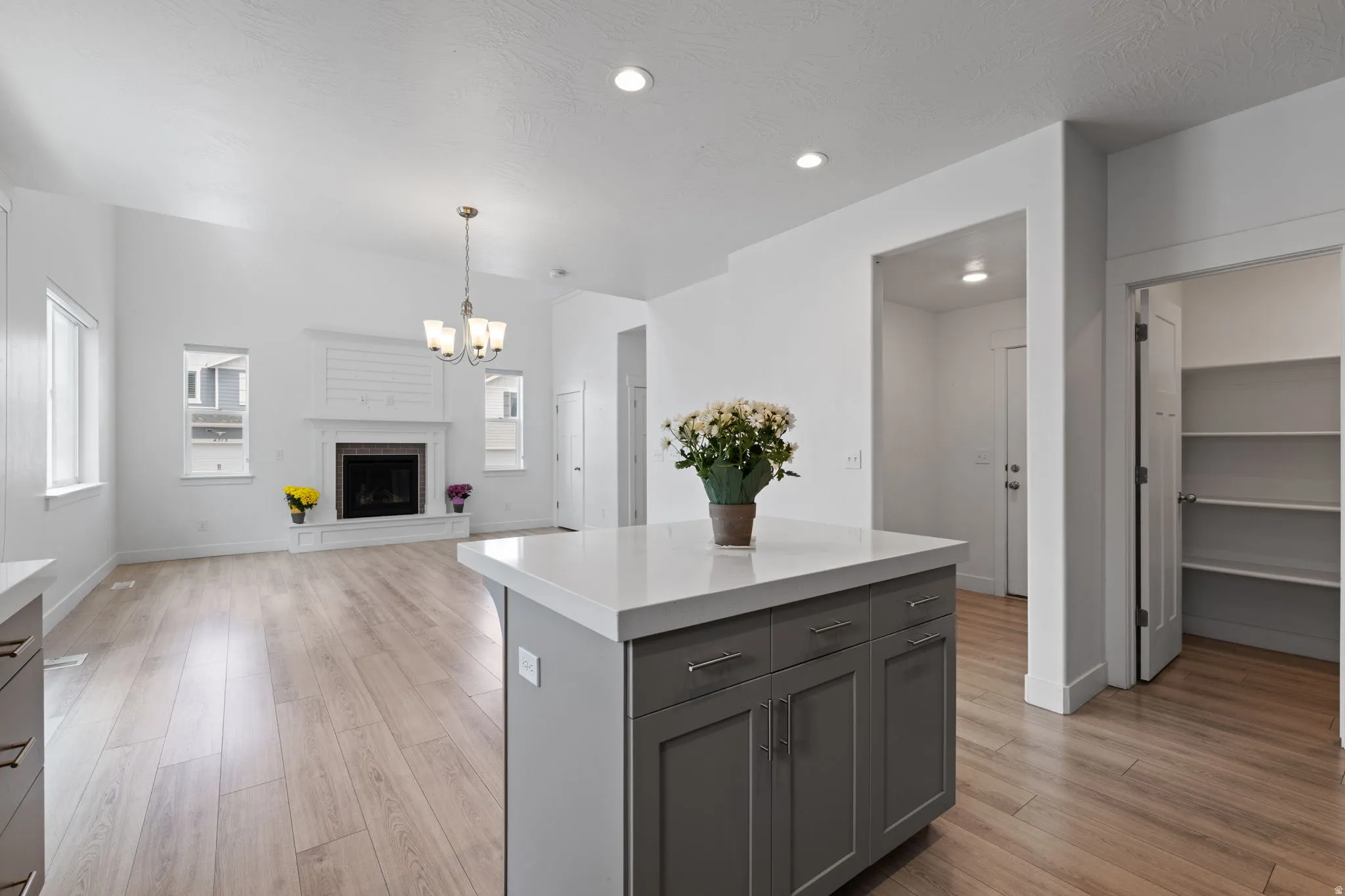 Kitchen island with a white countertop and gray cabinetry
