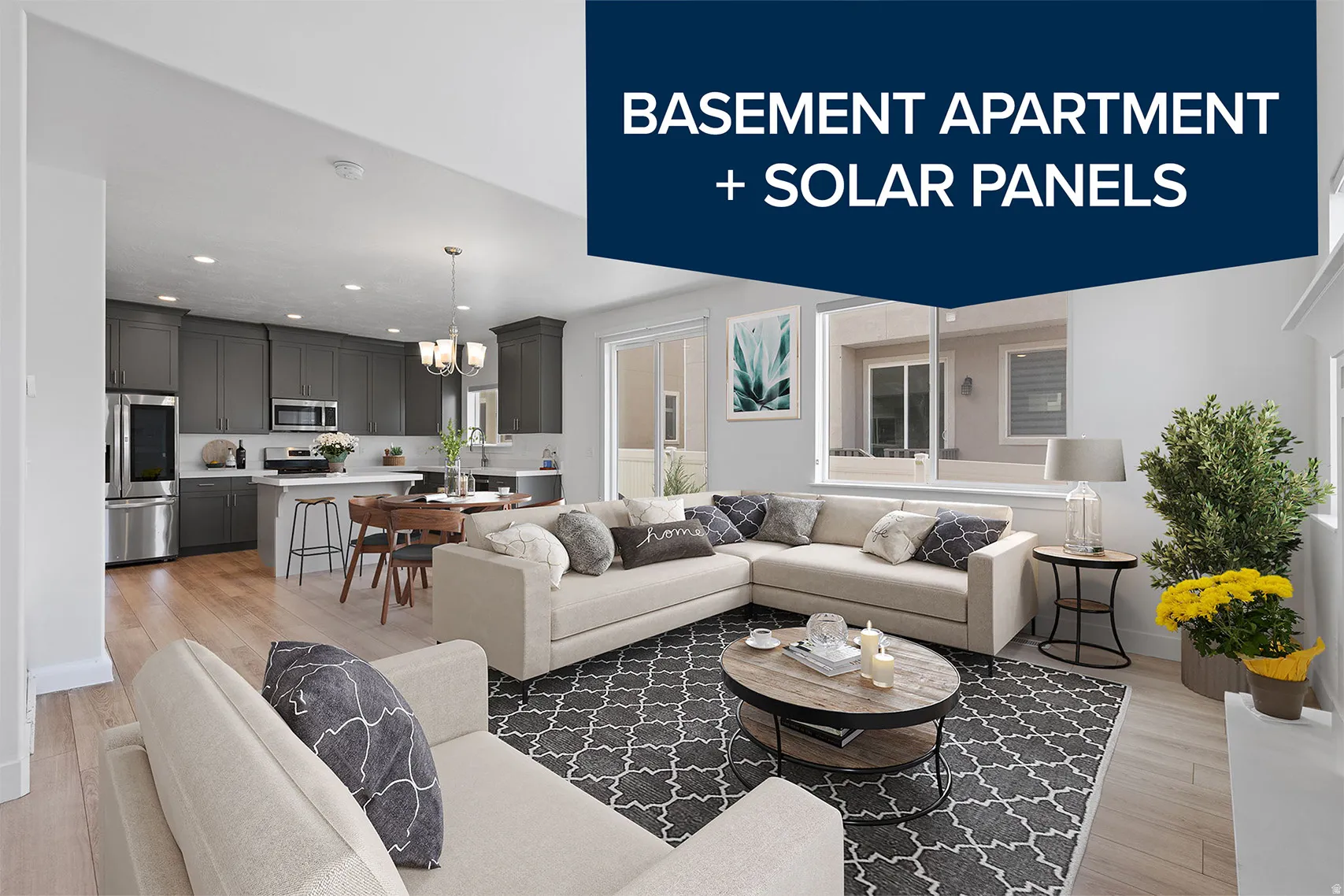 Open-concept living space featuring a kitchen with dark cabinetry, white countertops, and stainless steel appliances