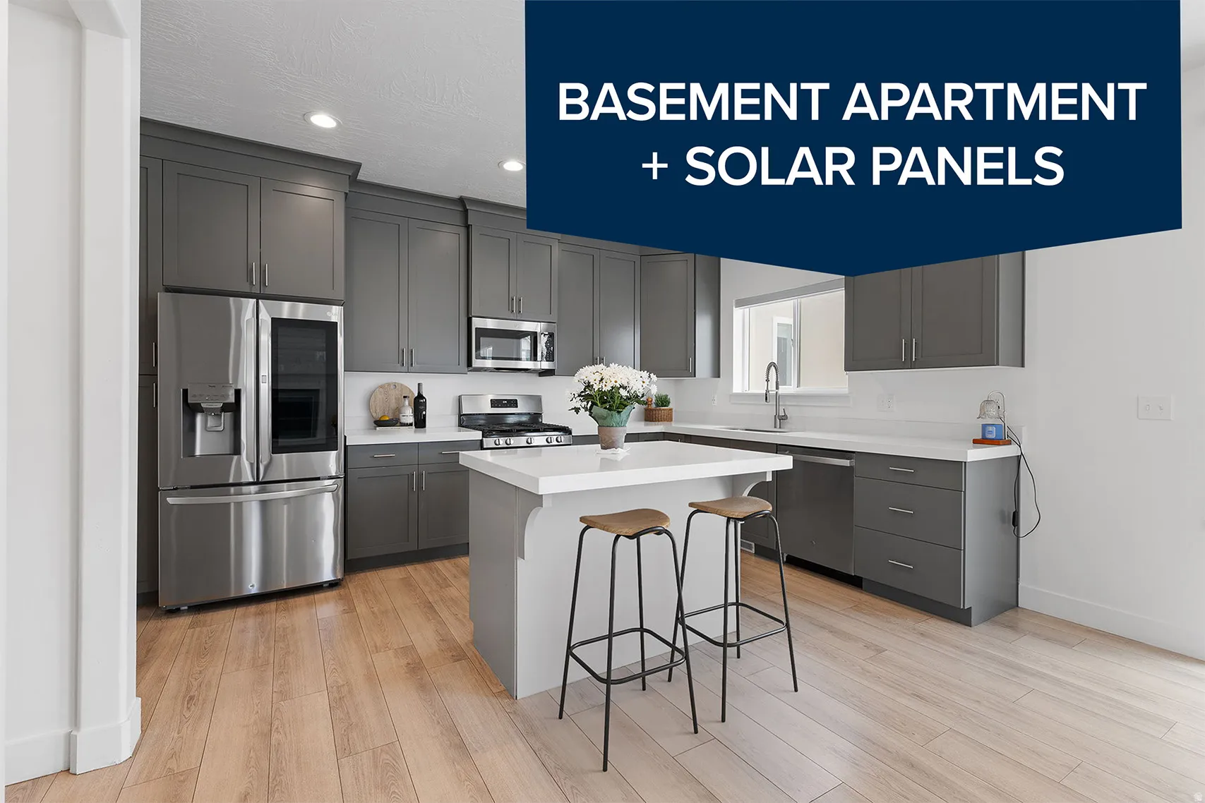 Modern kitchen featuring gray shaker-style cabinetry, white countertops, and stainless steel appliances