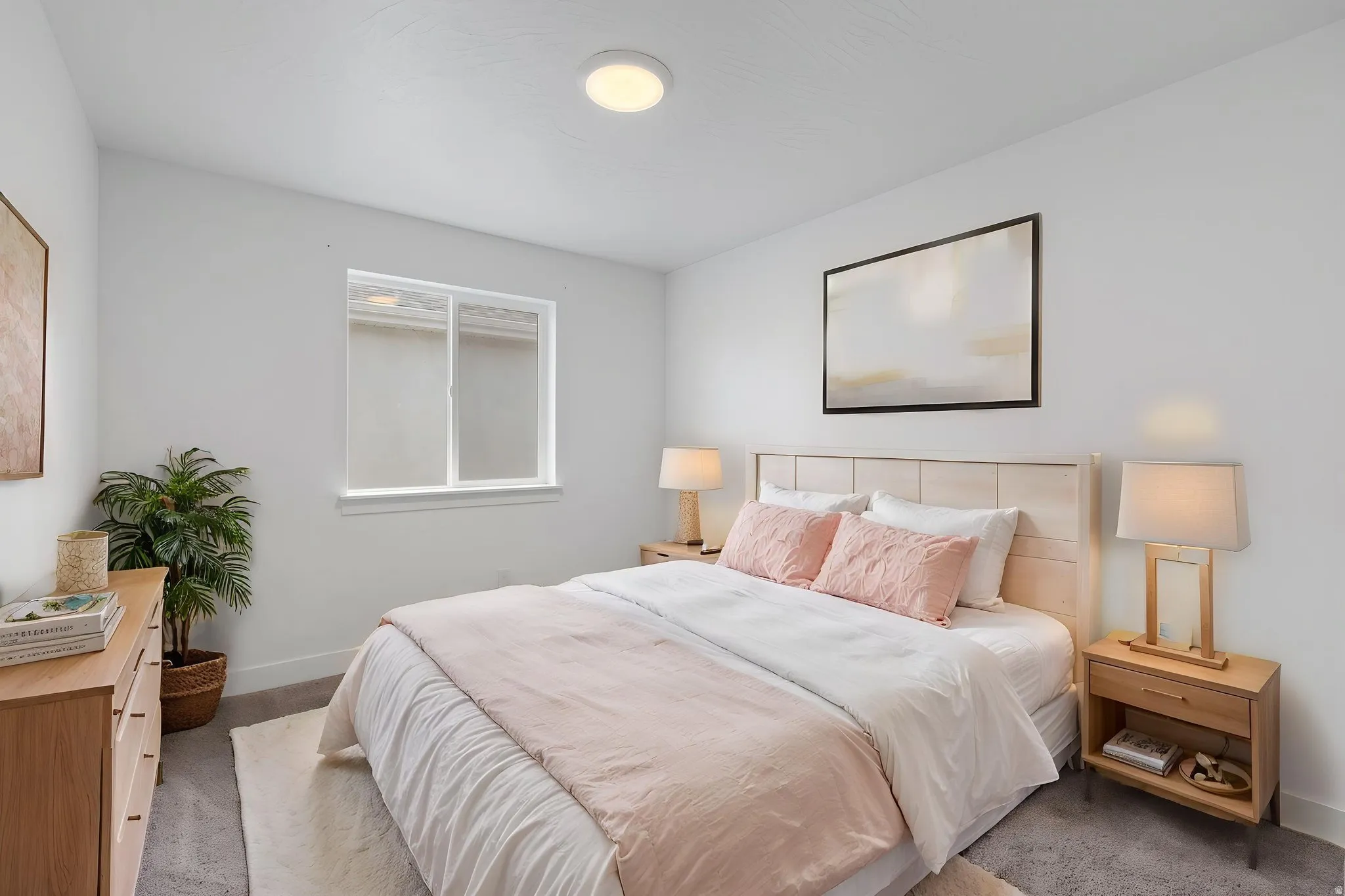 Bedroom featuring a light wood-finish headboard and frame, a window with white trim, a flush-mount ceiling light, and gray carpet flooring