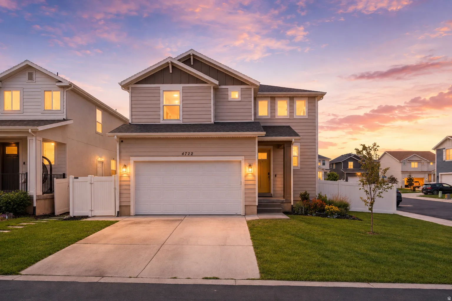 Contemporary two-story residence featuring light-toned horizontal siding with dark trim accents