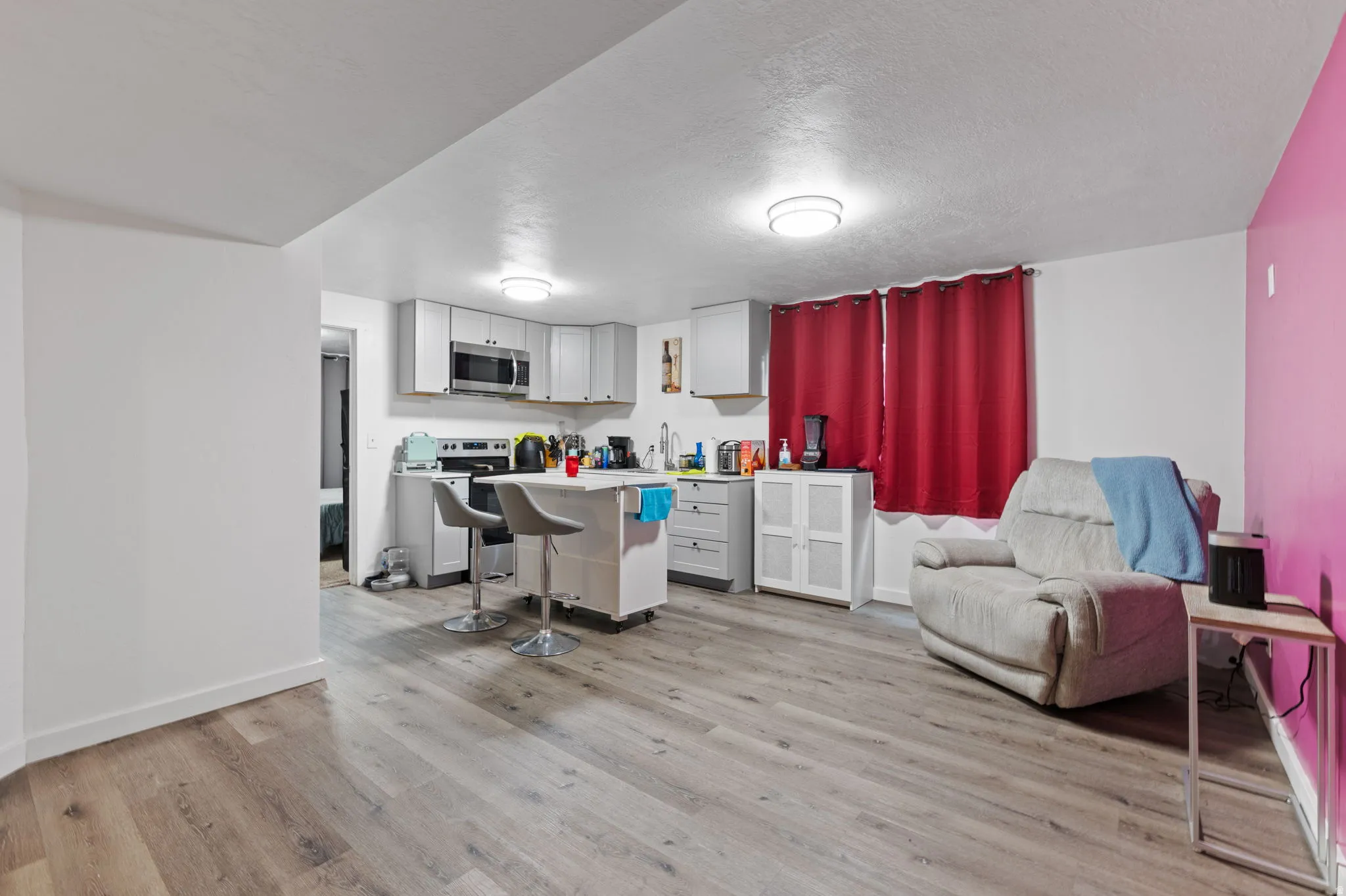 Open-concept living space with wood-finish flooring