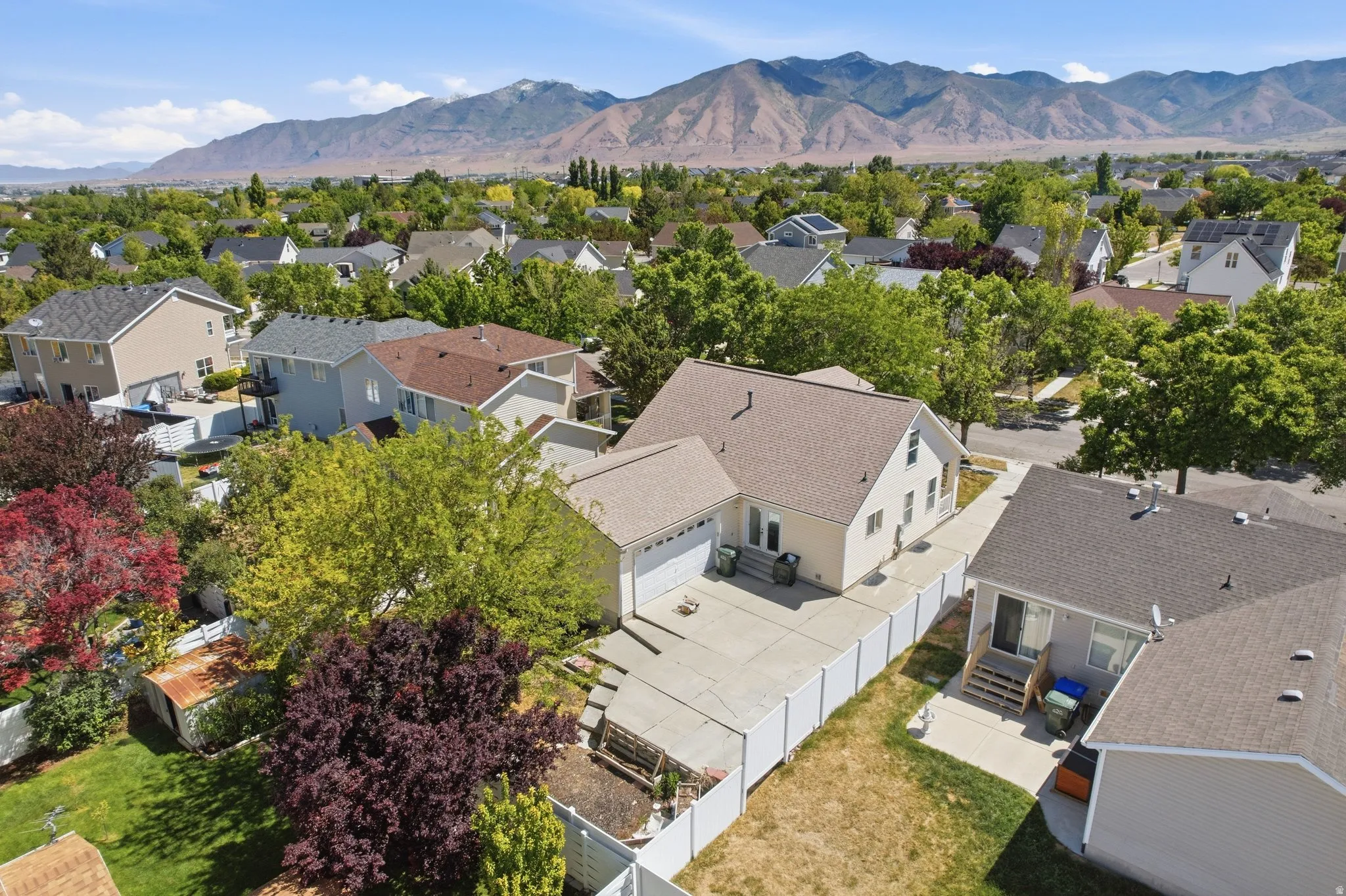 Aerial perspective showcasing a suburban neighborhood with mountain scenery