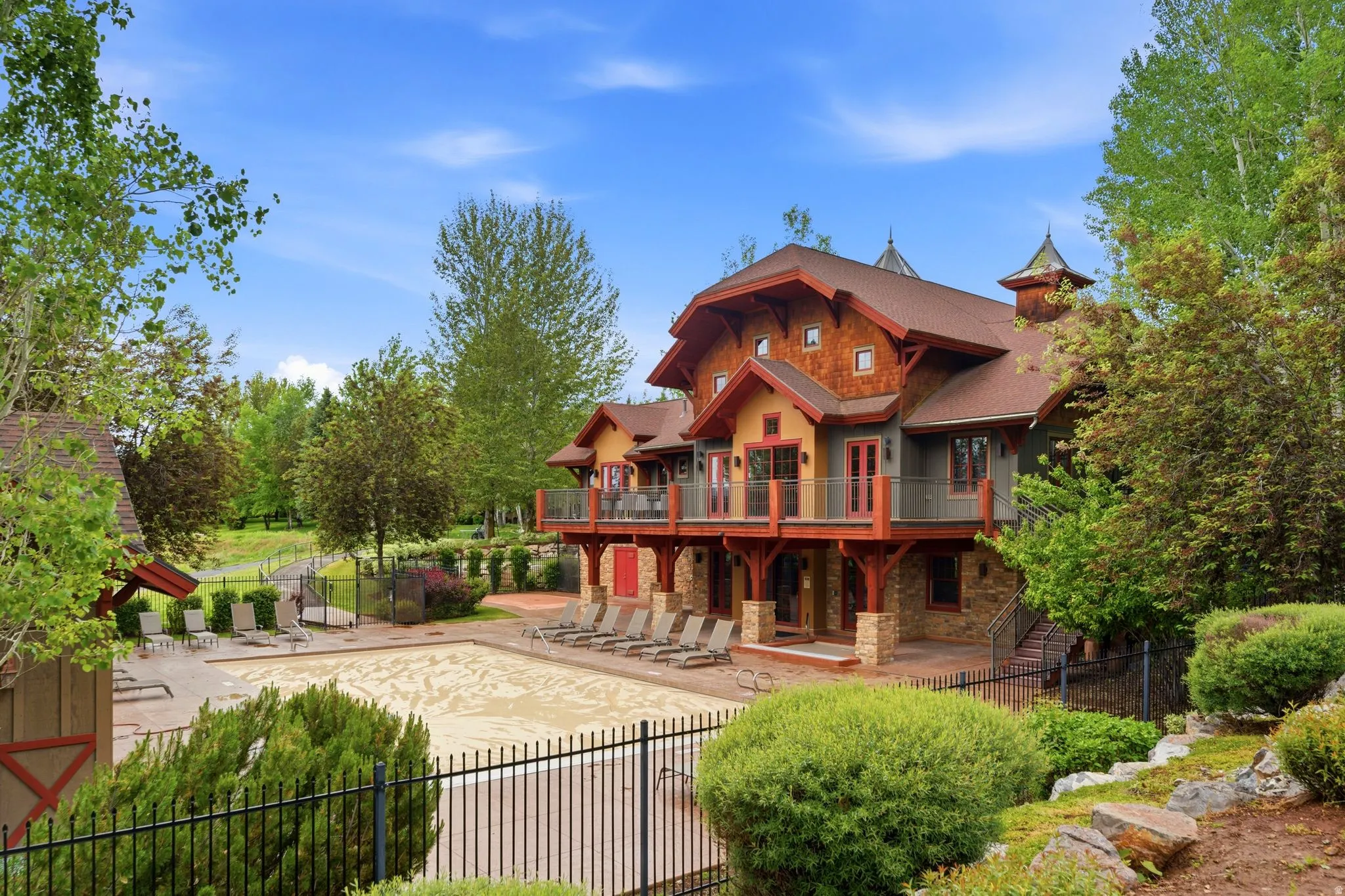 Multi-level exterior featuring stone veneer, shake siding, and wood trim accents