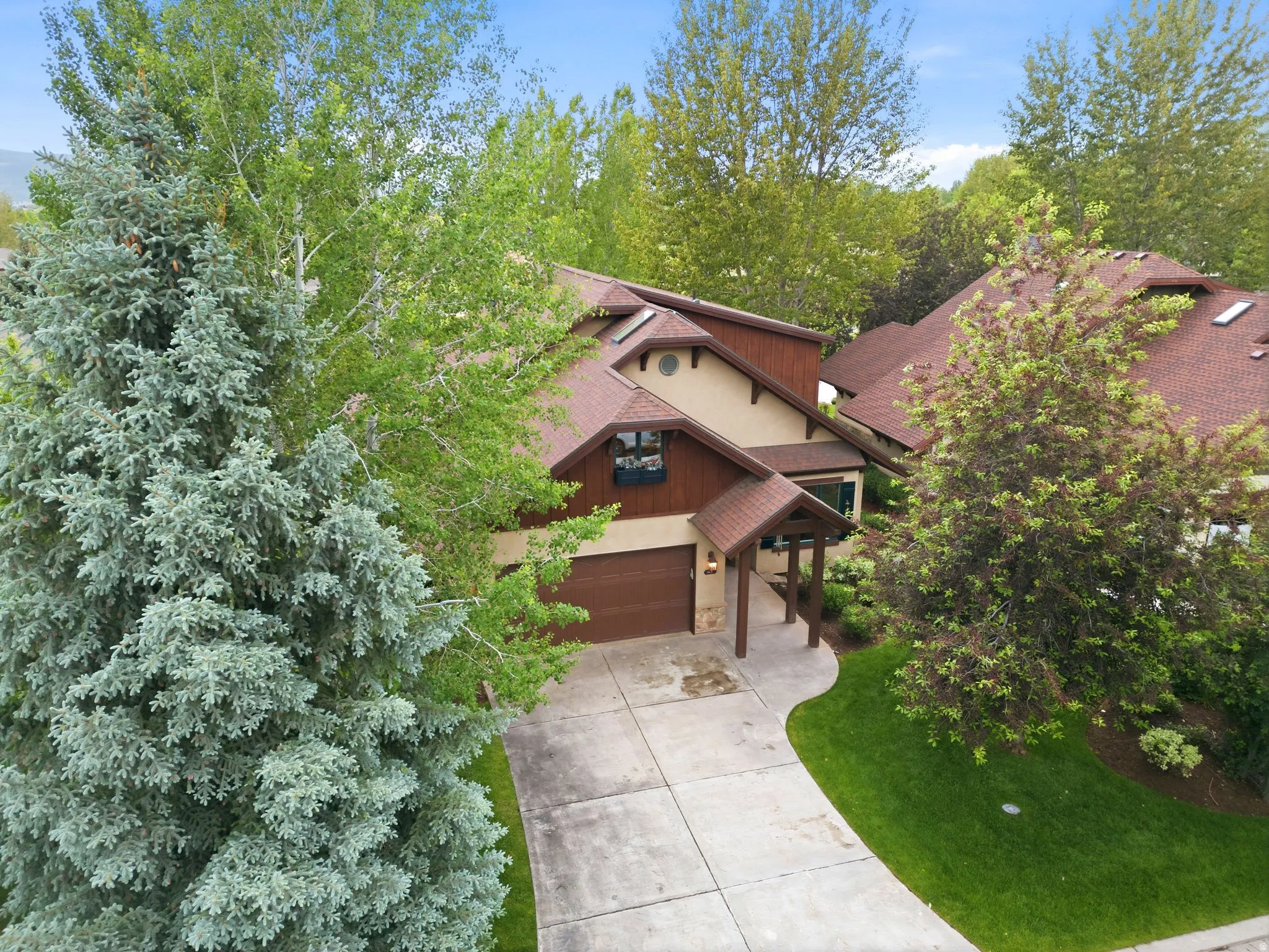 Warm-toned stucco exterior with brown siding accents