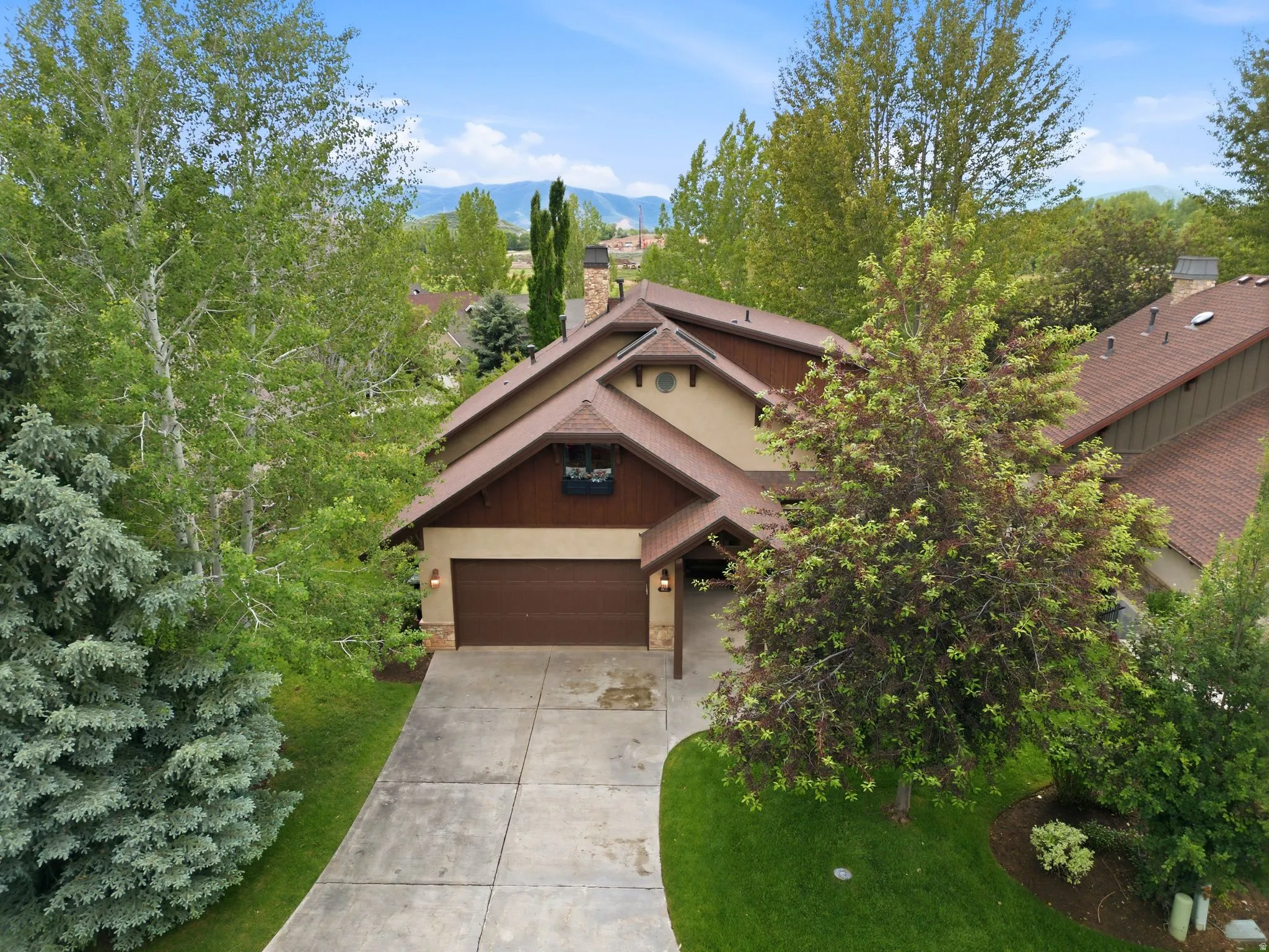 Two-story residence featuring a multi-gabled roofline and attached two-car garage