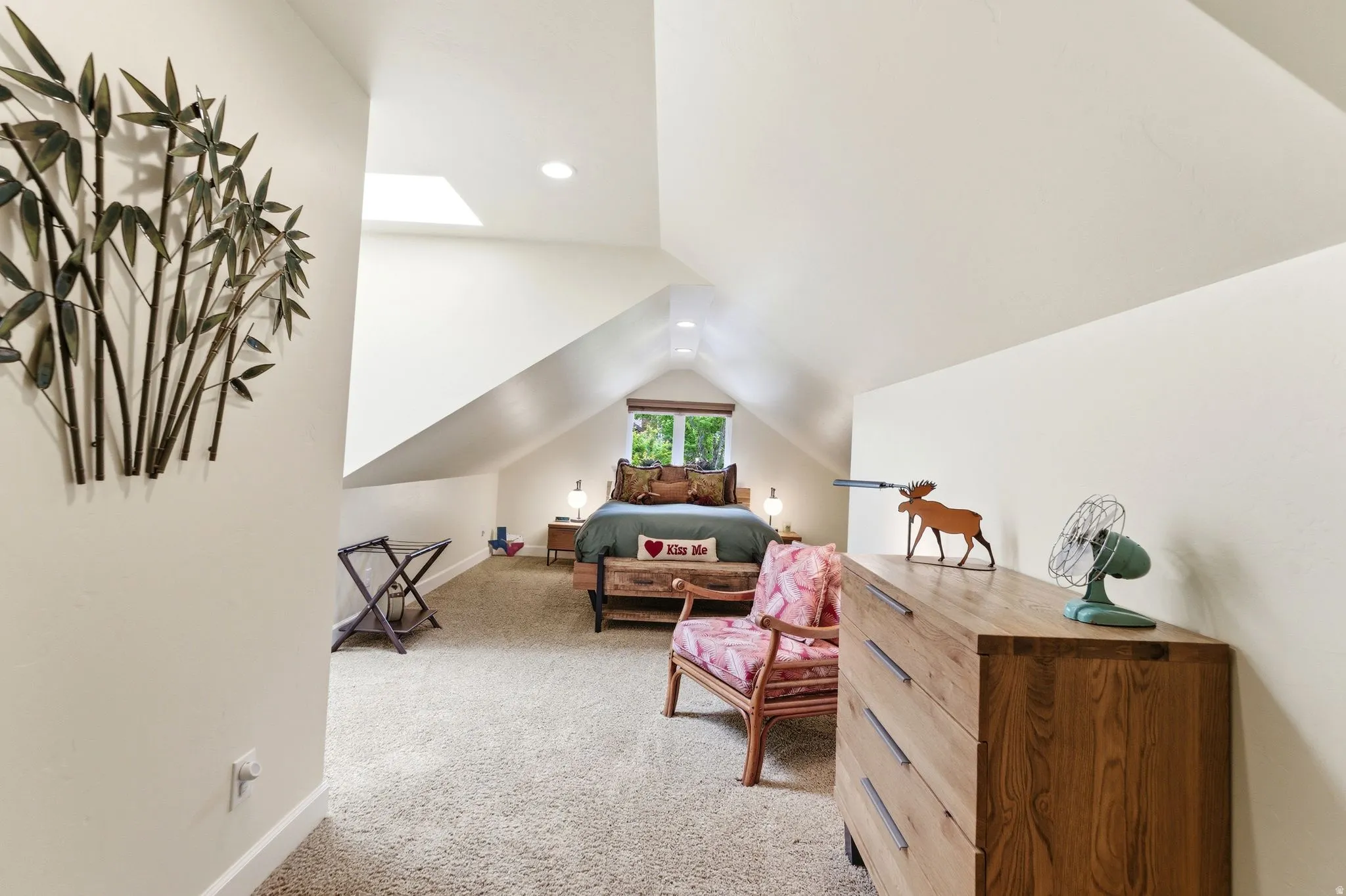 Carpeted bedroom with a vaulted ceiling, recessed lighting, and a skylight
