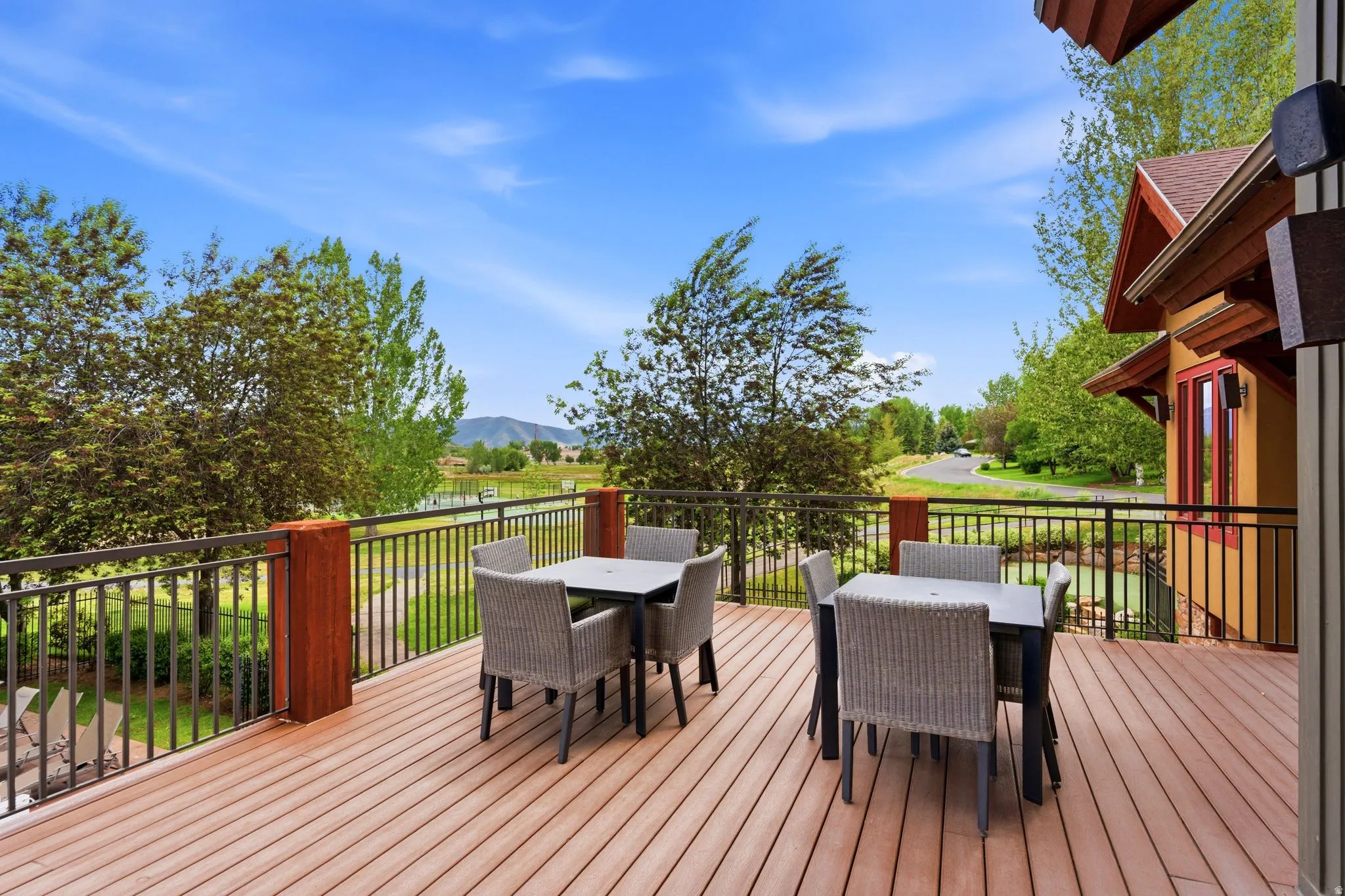 Expansive outdoor deck featuring wood-finish composite decking and dark metal railings