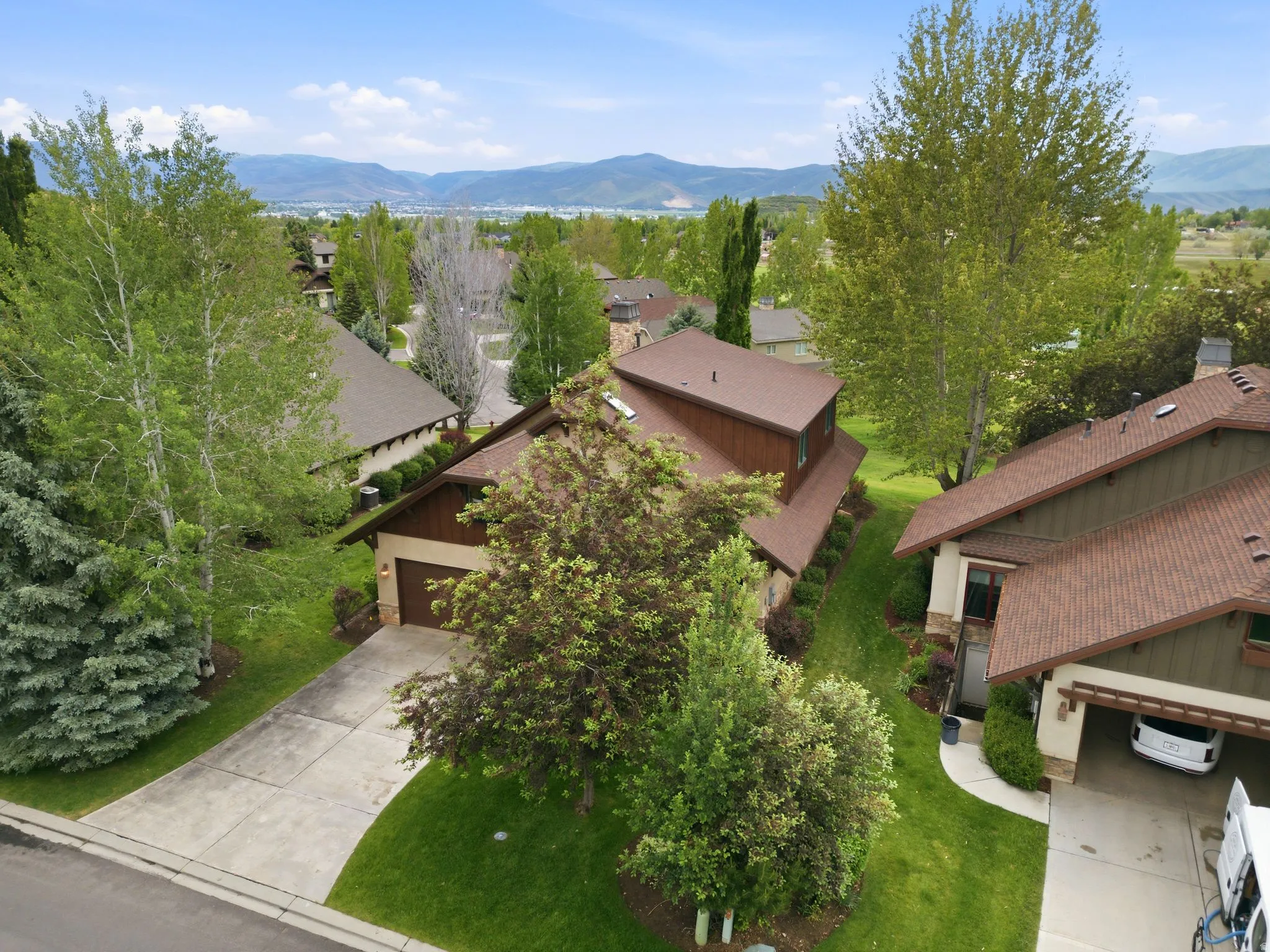 Residential property featuring a brown shingle roof and a two-car garage