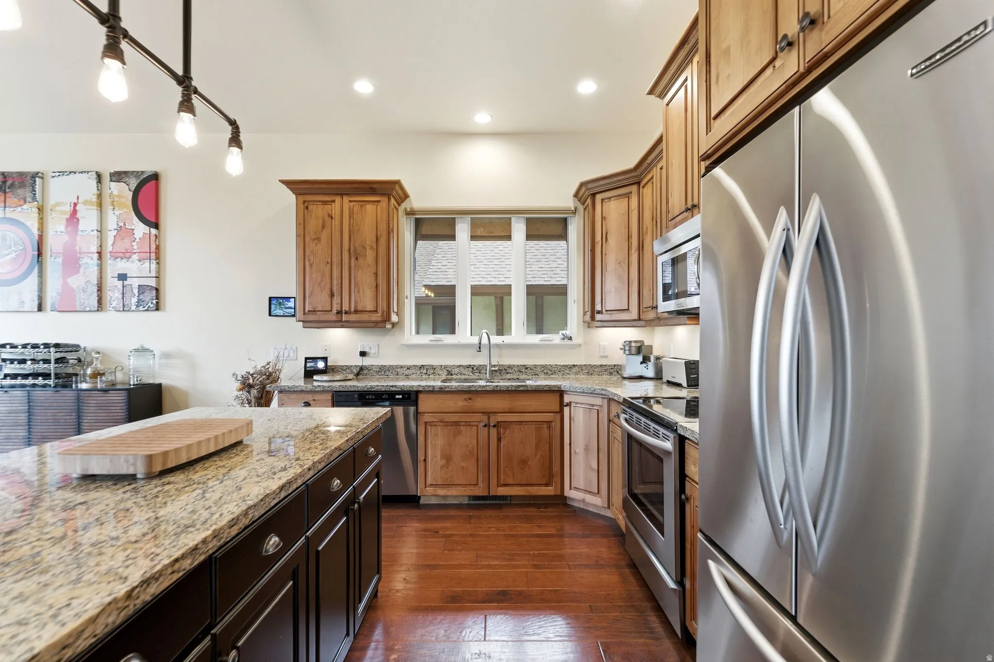 Kitchen featuring wood-finish flooring, recessed lighting, and a kitchen island with a granite countertop