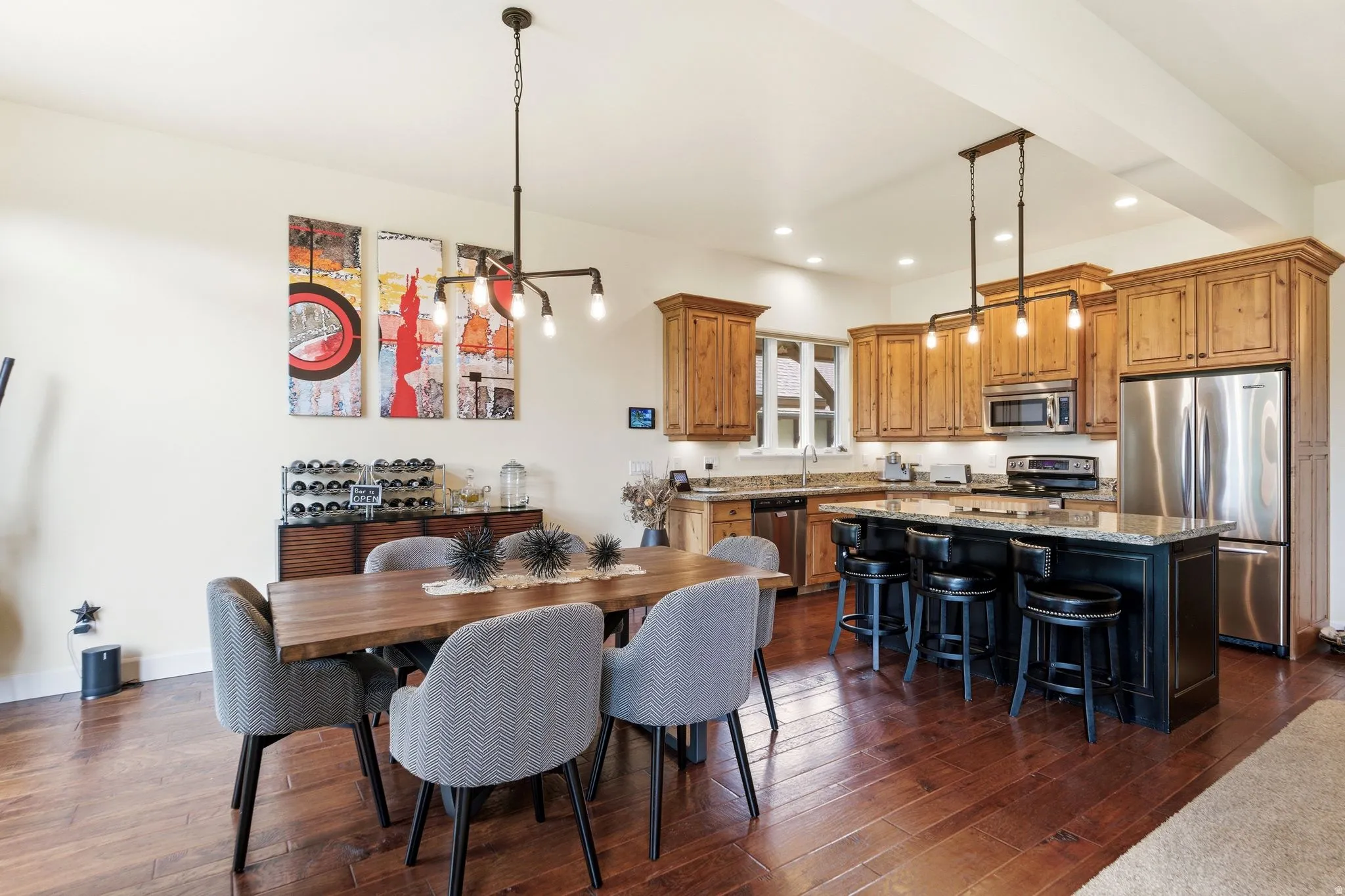 Open-concept kitchen and dining area featuring wood-finish flooring