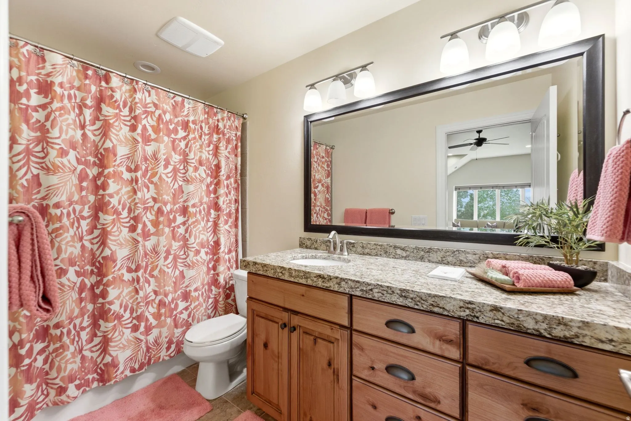 Bathroom vanity featuring a light-toned granite-style countertop