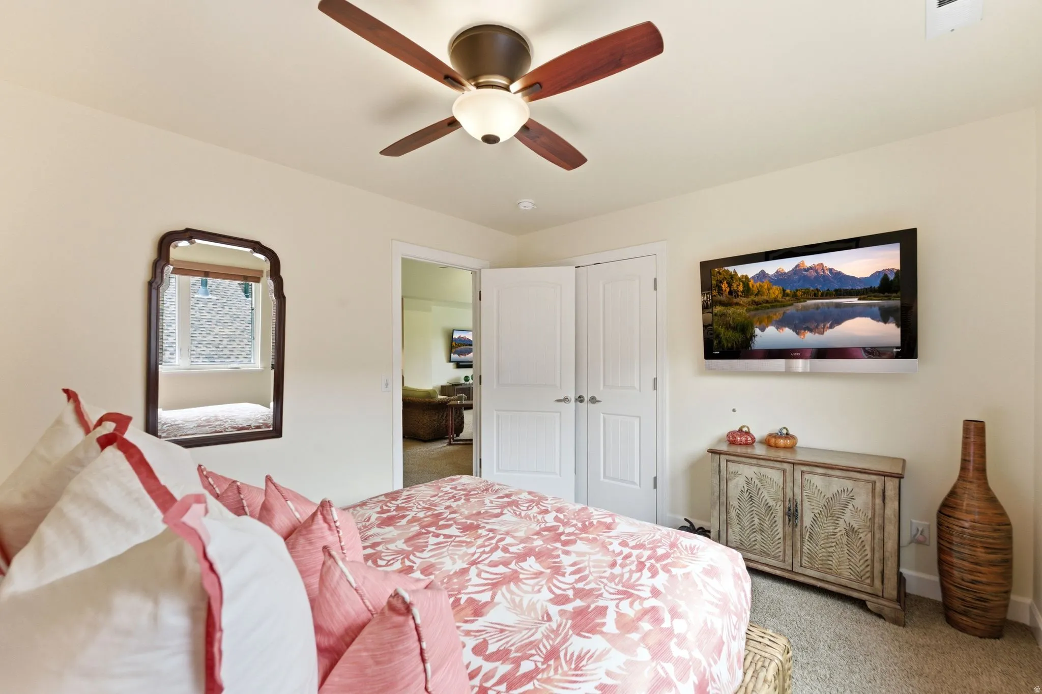 Room featuring neutral painted walls, light carpet flooring, and a ceiling fan with integrated lighting