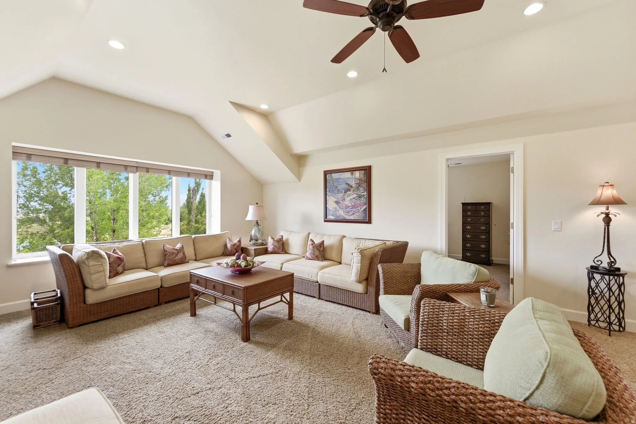 Spacious bonus room featuring a wide window, sloped ceilings, recessed lighting, a ceiling fan, and carpet flooring