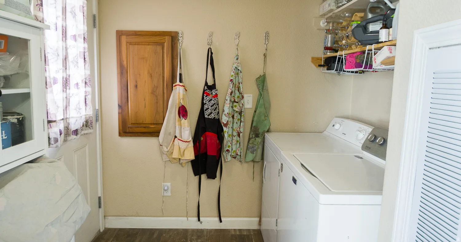 Laundry area featuring wood-finish flooring and neutral wall tones