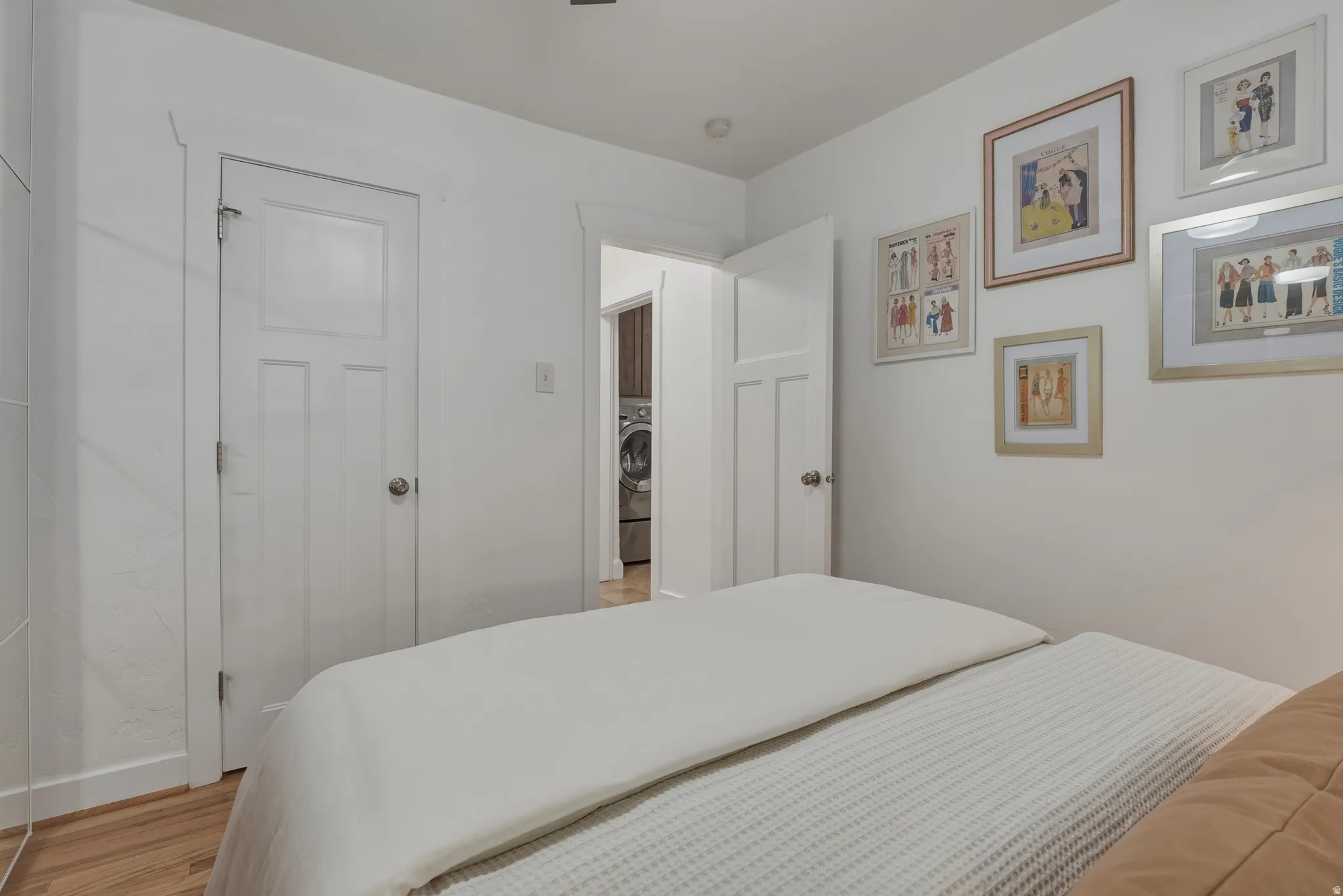 Bedroom with light-toned wood-finish flooring