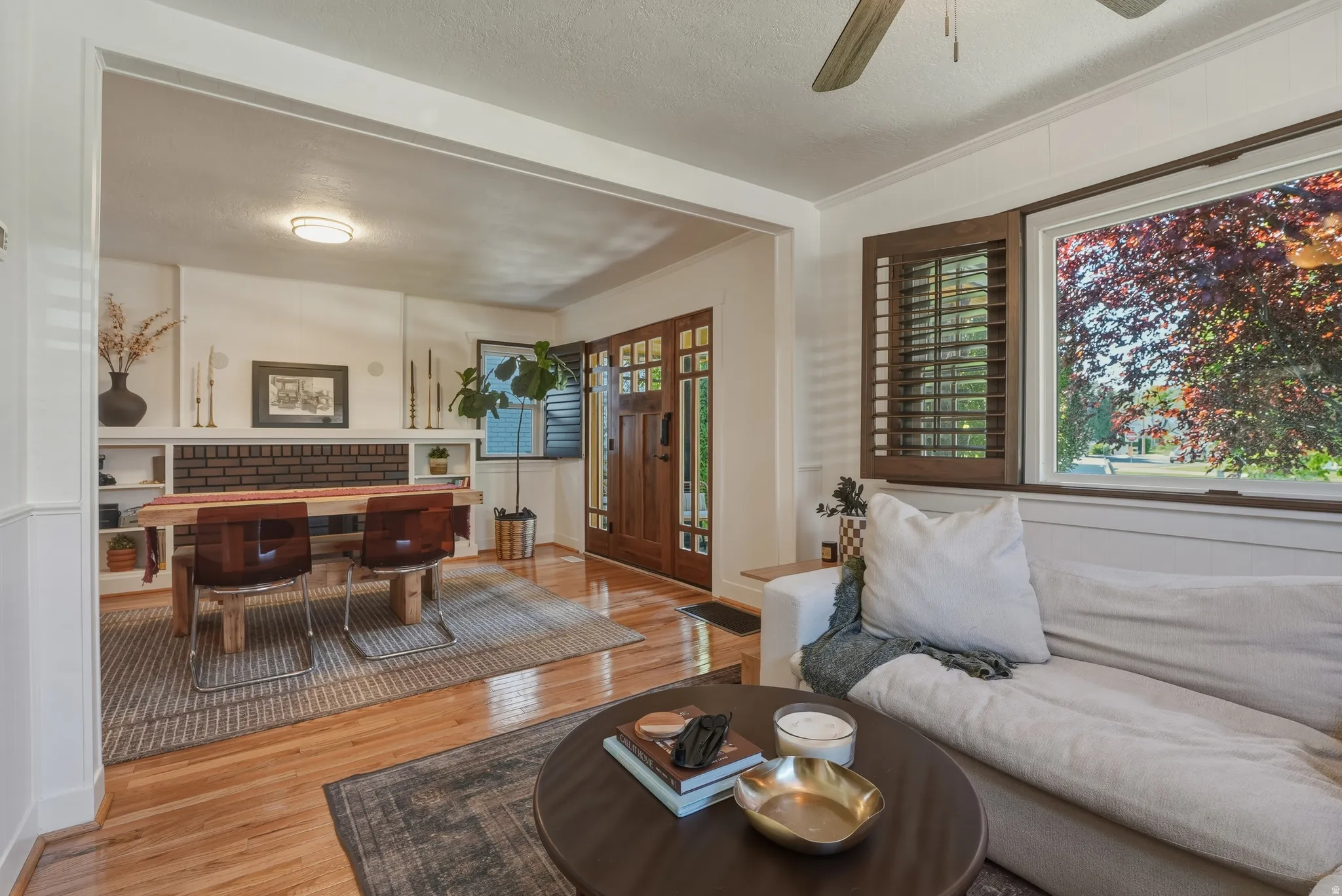 Bright interior space featuring wood-finish flooring and white wainscoting