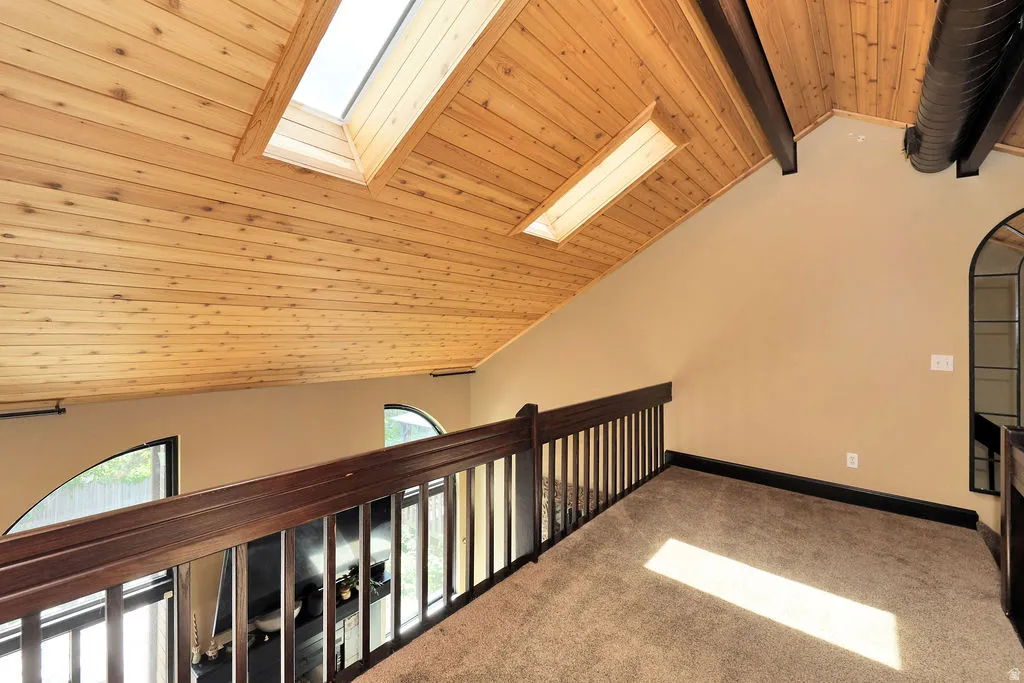 Bonus space at top of the stairs features vaulted wood-finish ceiling with skylights